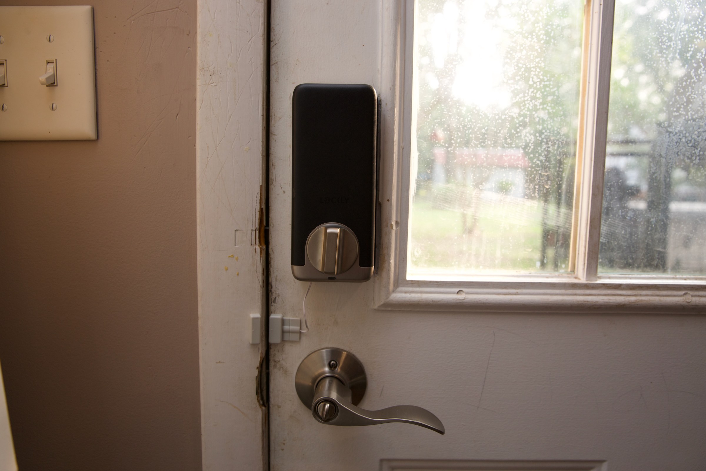 The wired plastic door sensor is a letdown, ugly and non-removable — it’s not a good look.