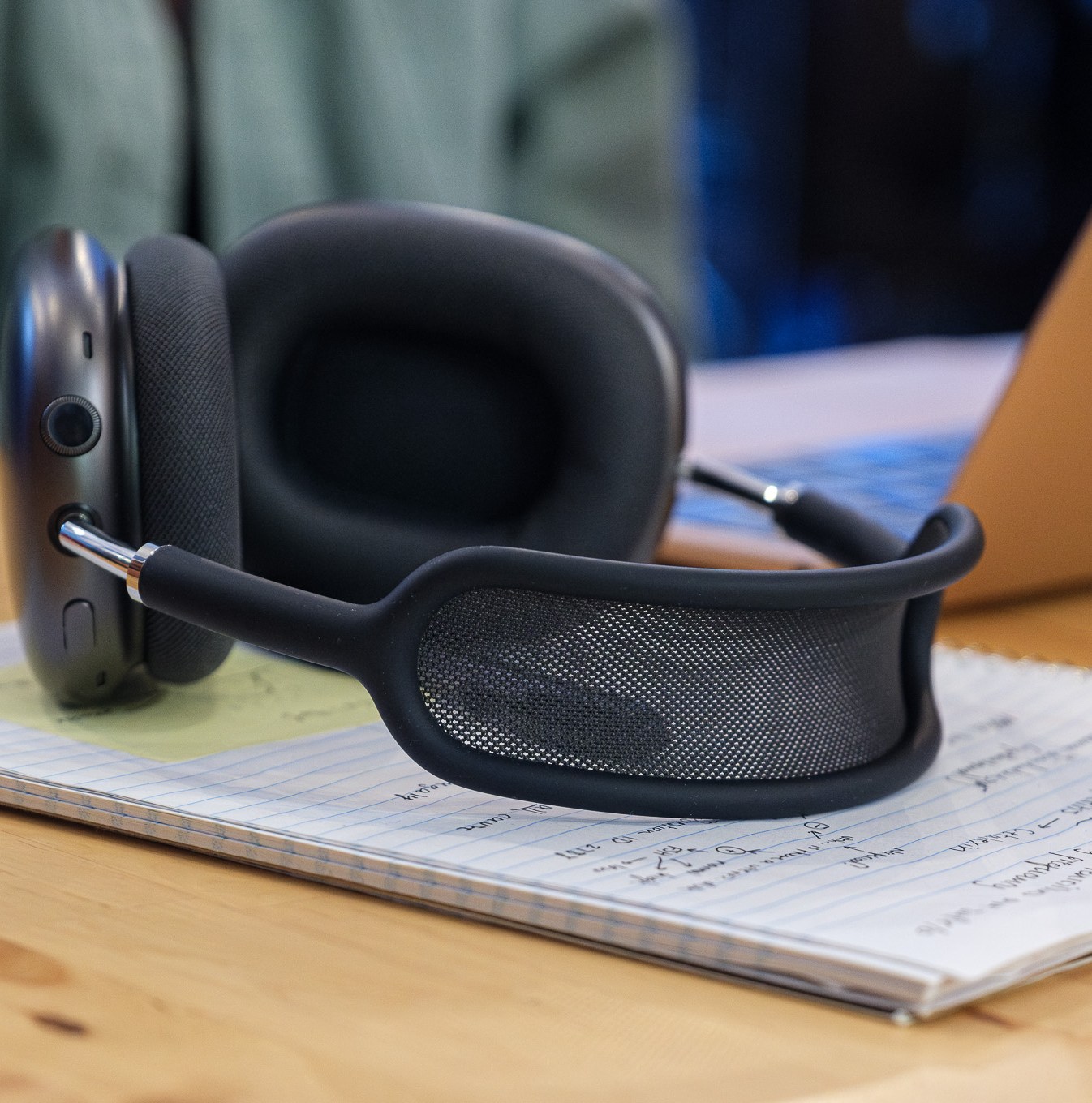 A photo of Apple’s AirPods Max headphones on a coffee shop table.