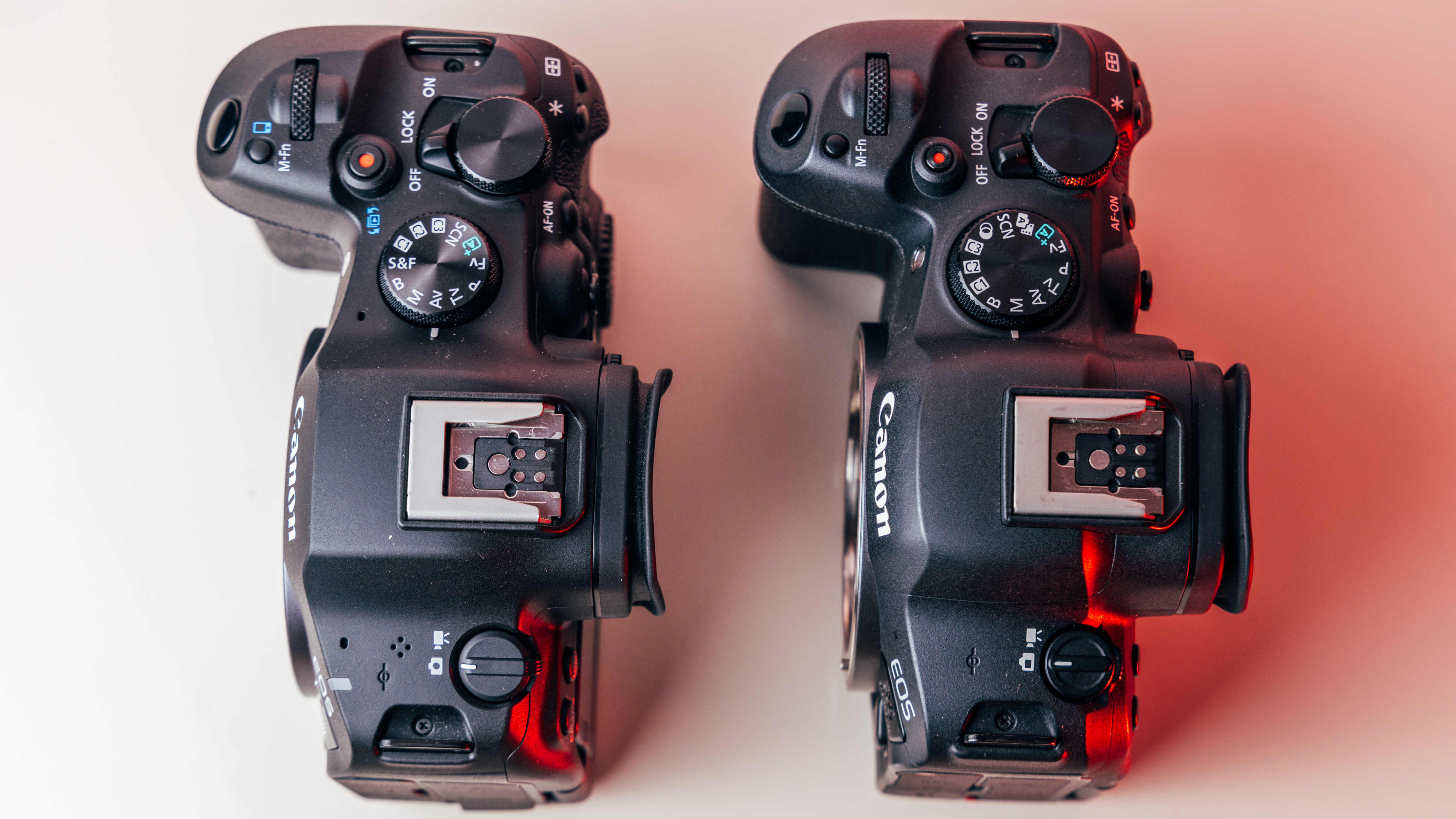 A top-down shot of the R6 Mark III next to the R6 Mark II showing the control layout of both cameras.