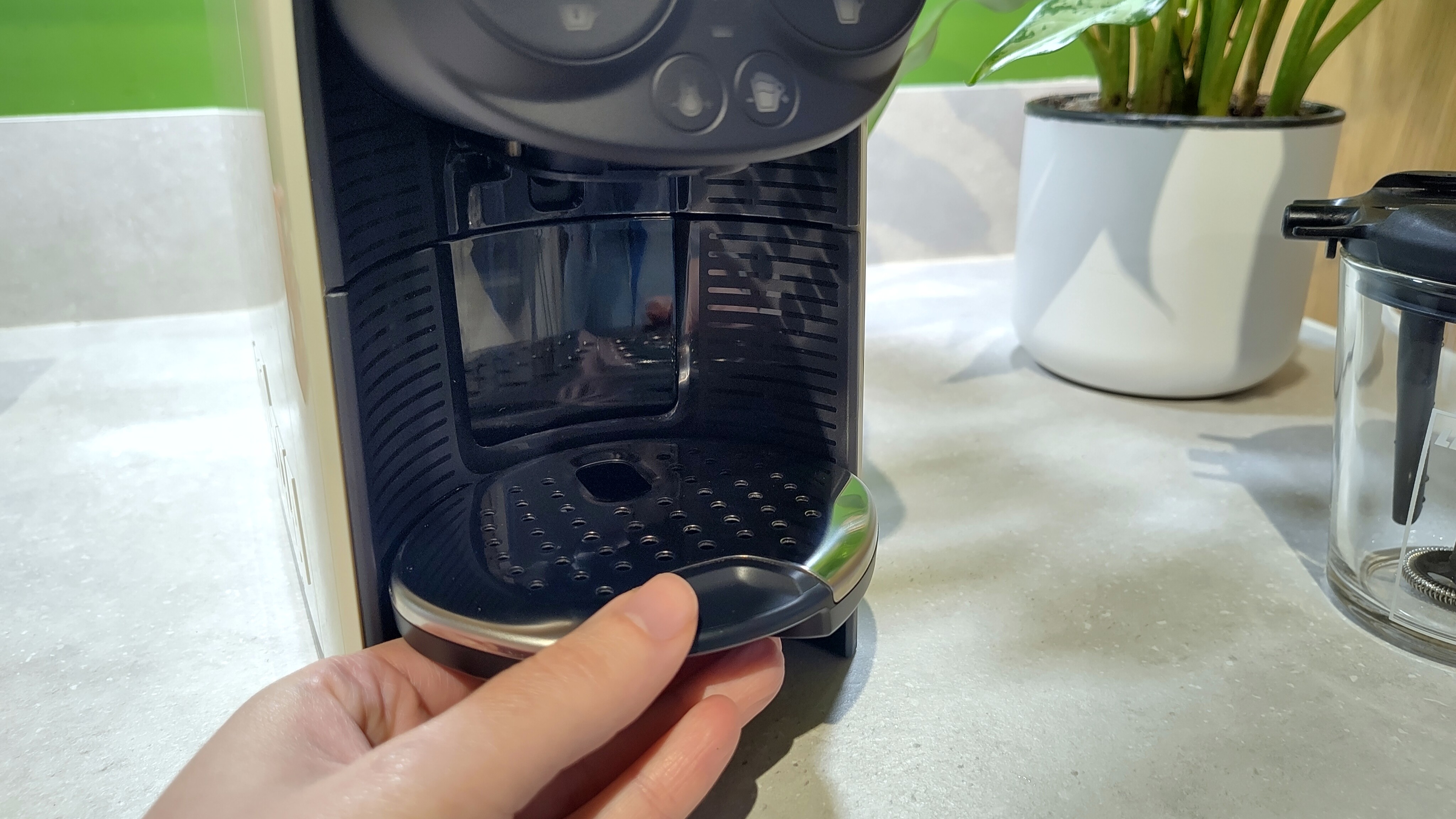 Person adjusting height of drip tray on Lavazza A Modo Mio Deséa coffee maker