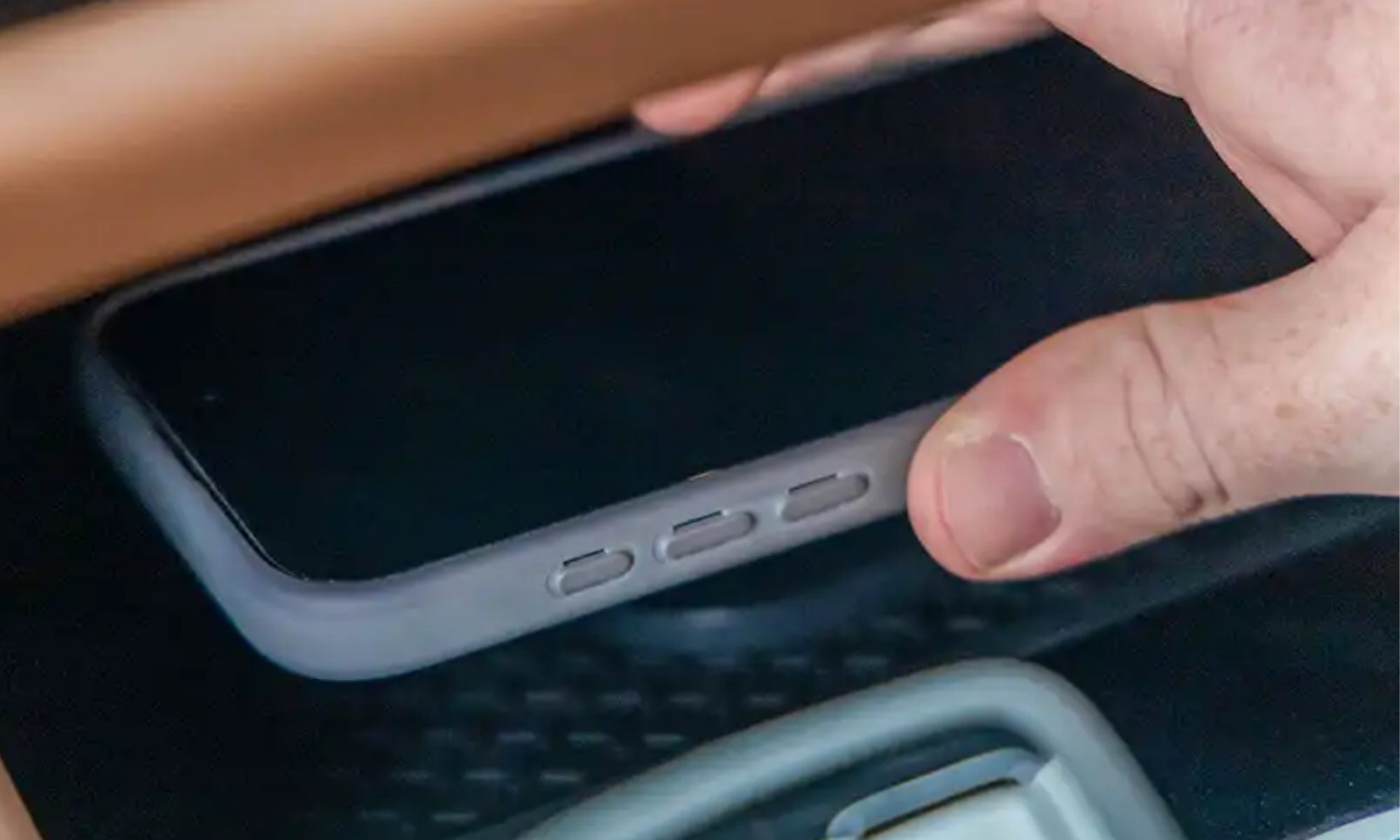 Smartphone being docked on the magnetic wireless charging dock in Nissan cars.