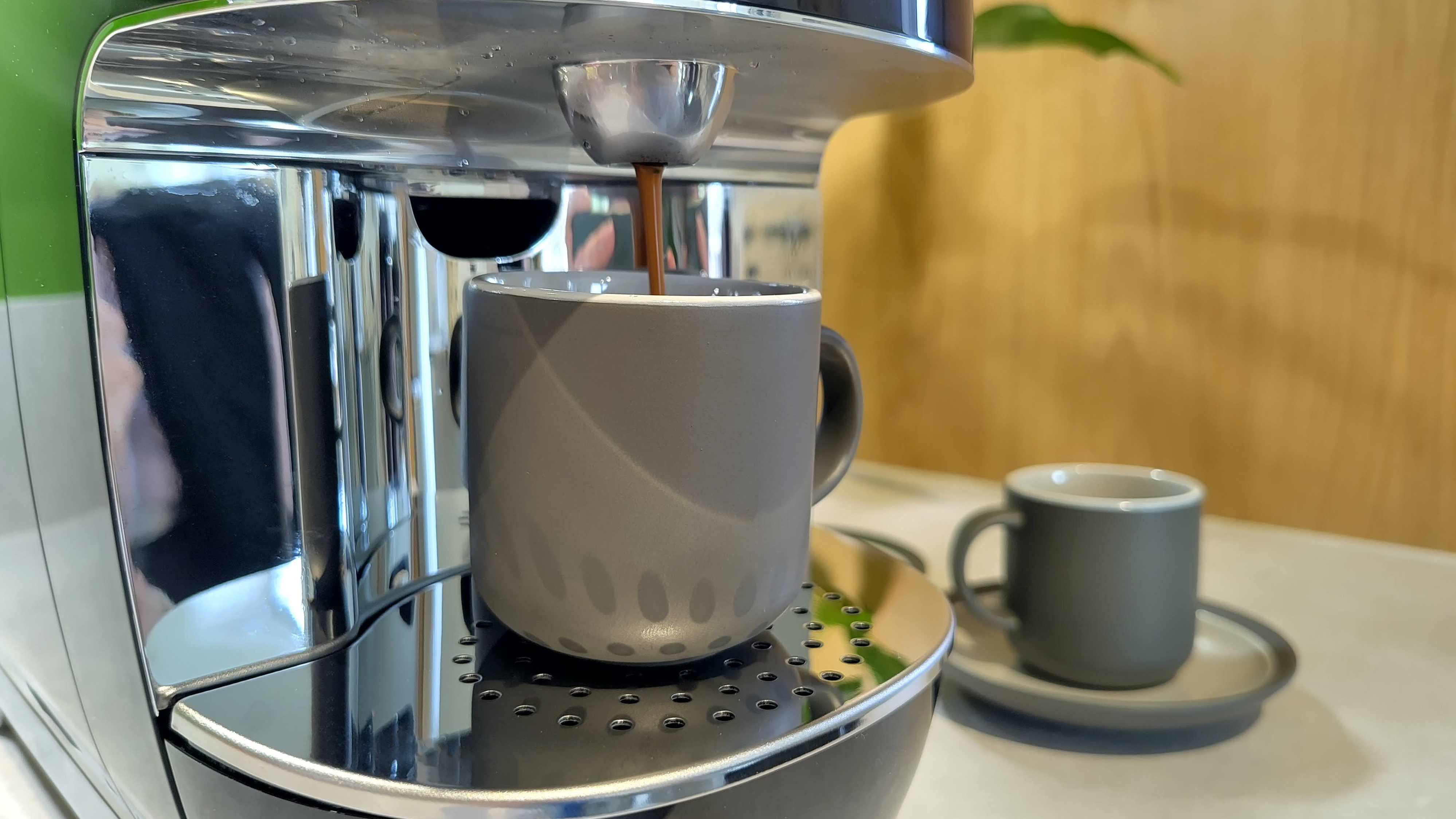 Lavazza A Modo Mio Smeg coffee maker dispensing espresso into cup