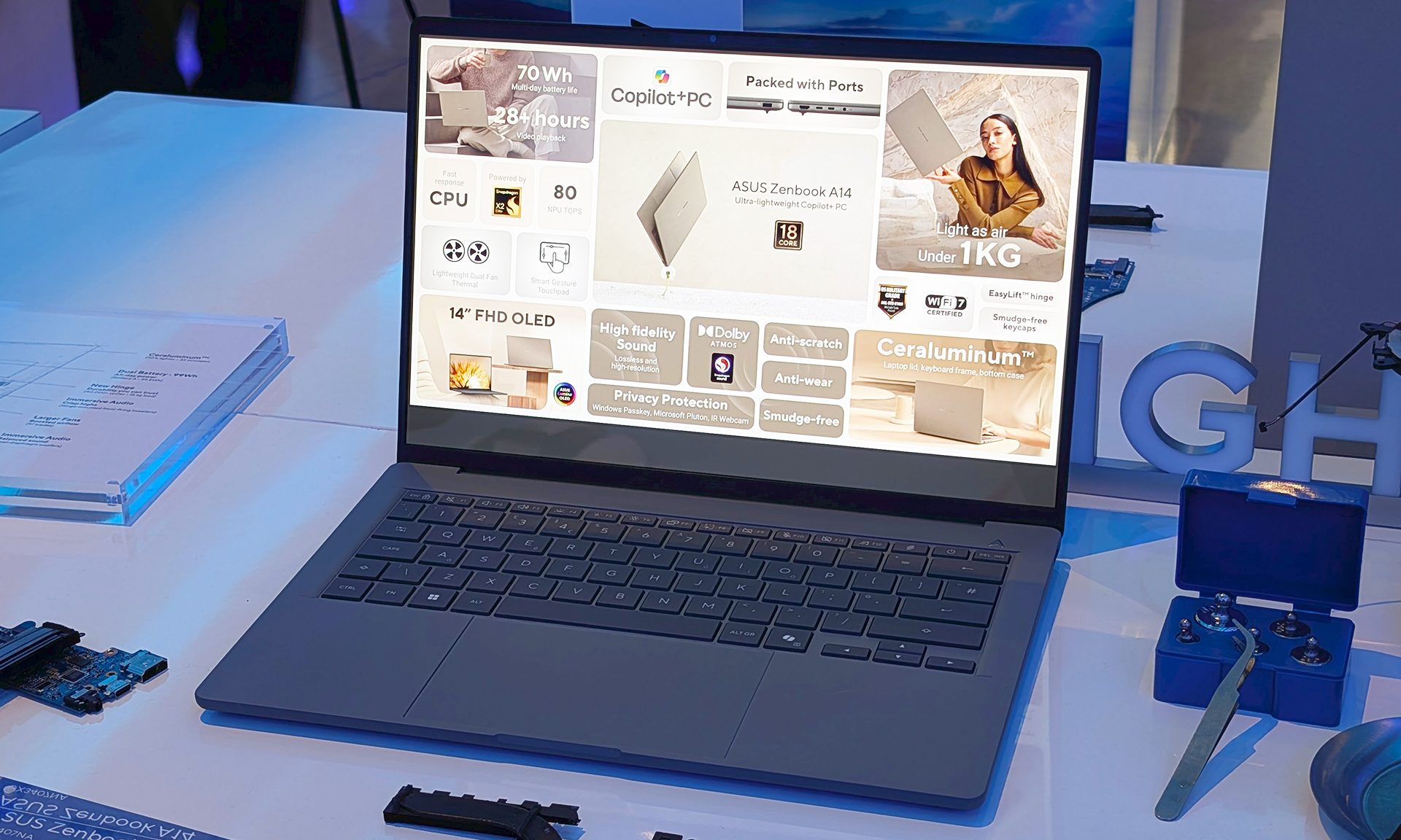 Zenbook A14 sitting open on a white table.