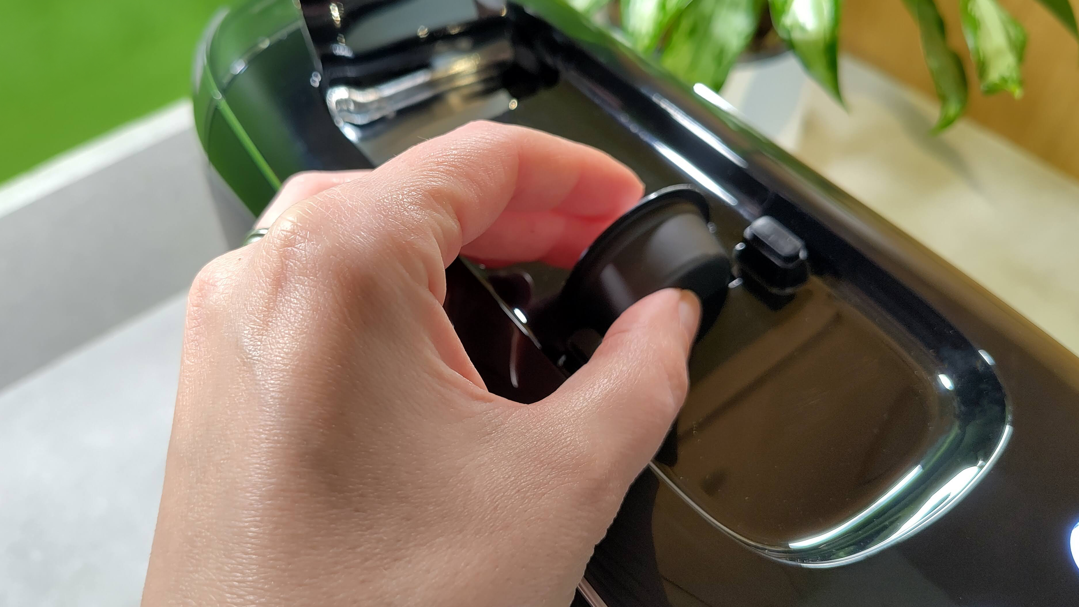 Person inserting coffee pod into Lavazza A Modo Mio Smeg coffee maker
