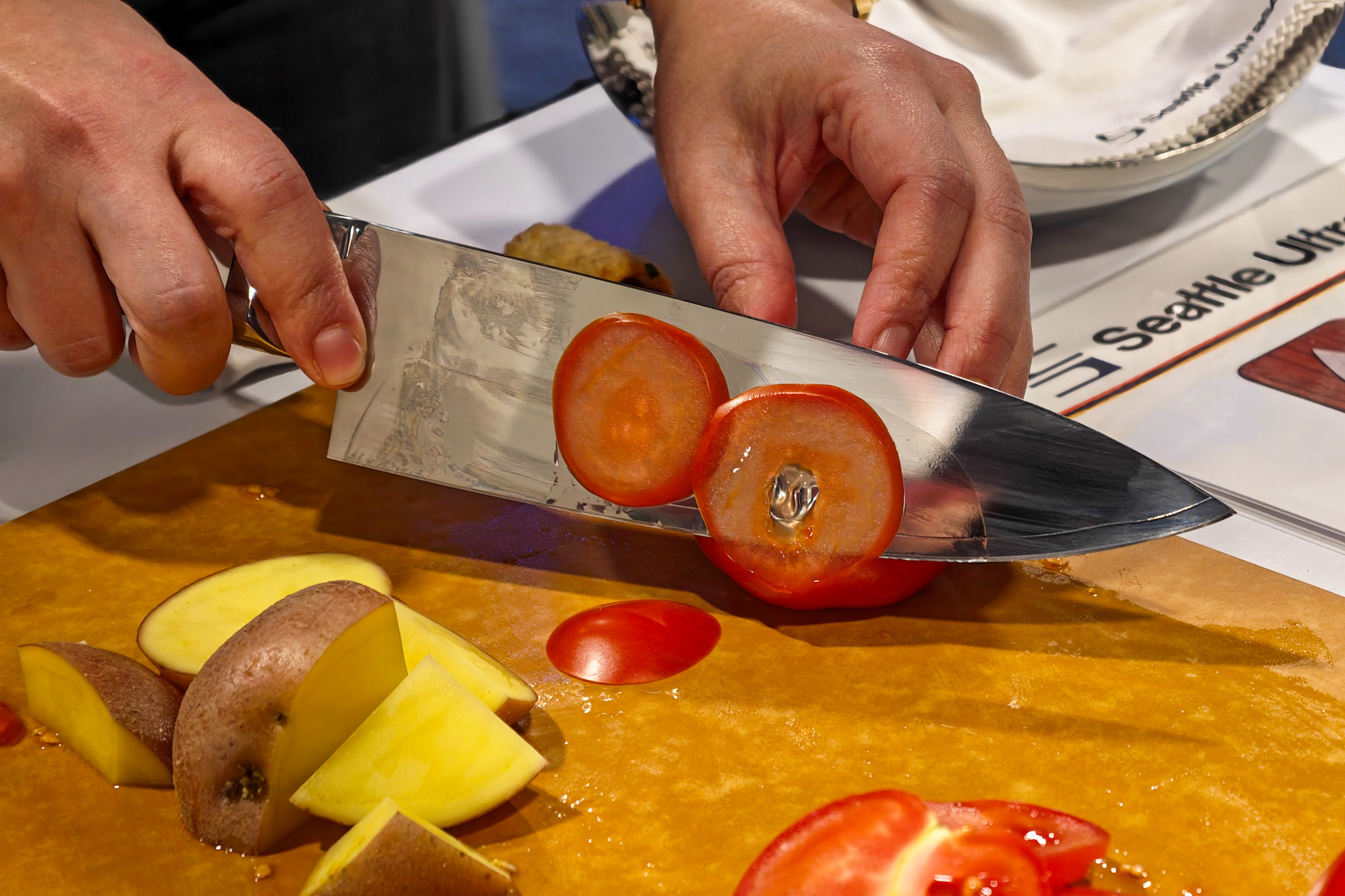 Photo of the Seattle Ultrasonics C-200 knife slicing a tomato