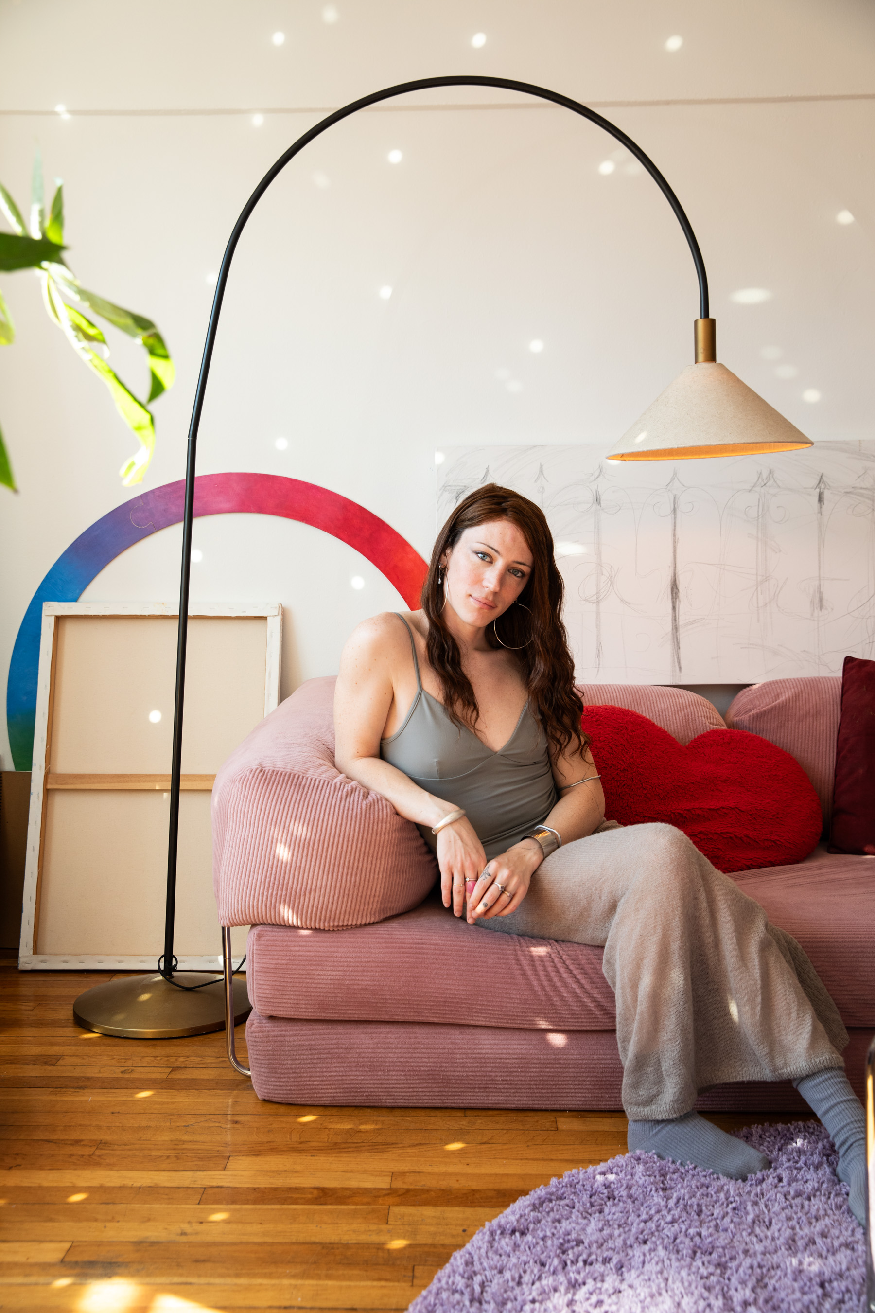 Bree sits on a sofa in her room.