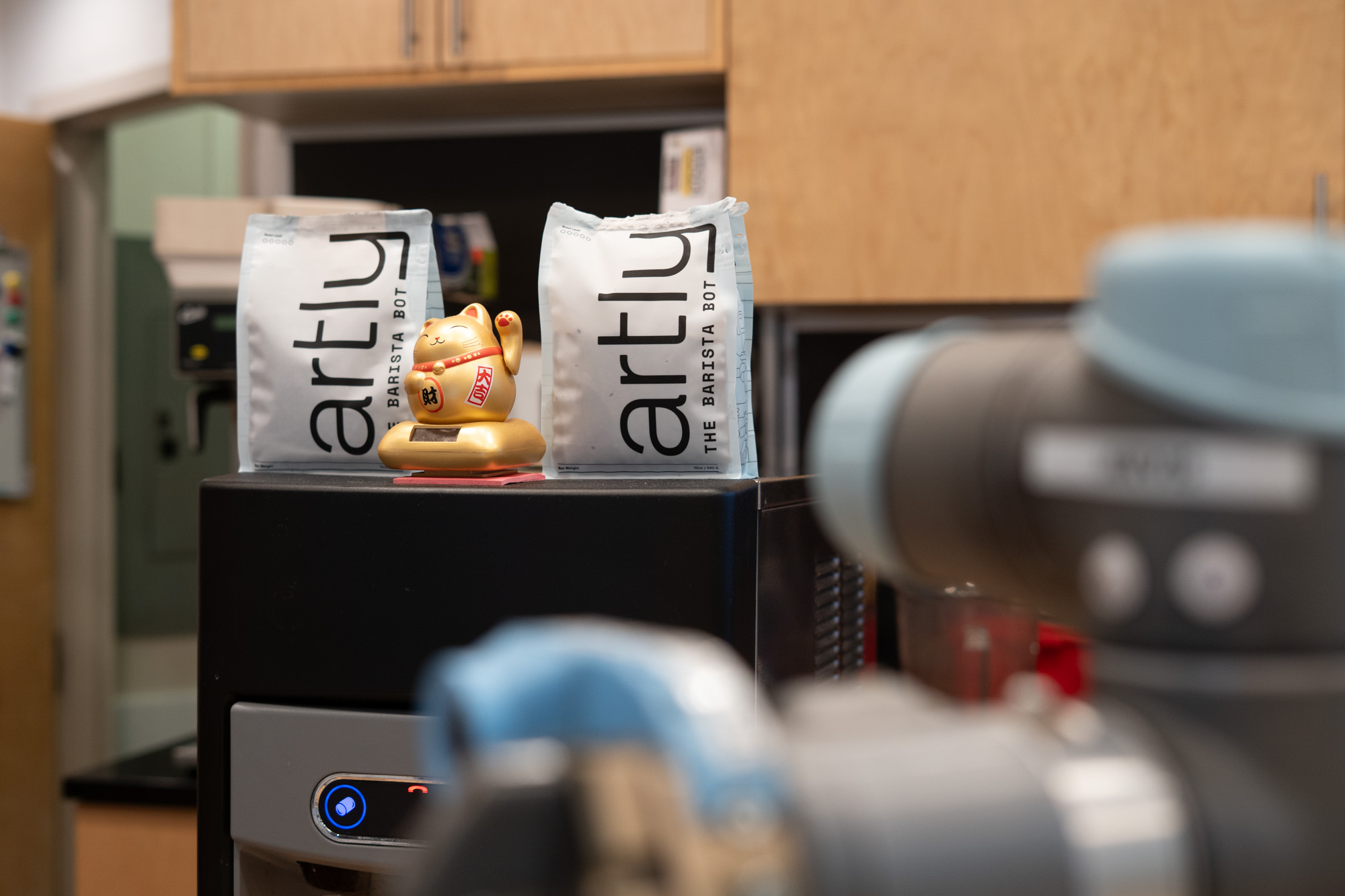 A lucky waving cat in robot barista cafe