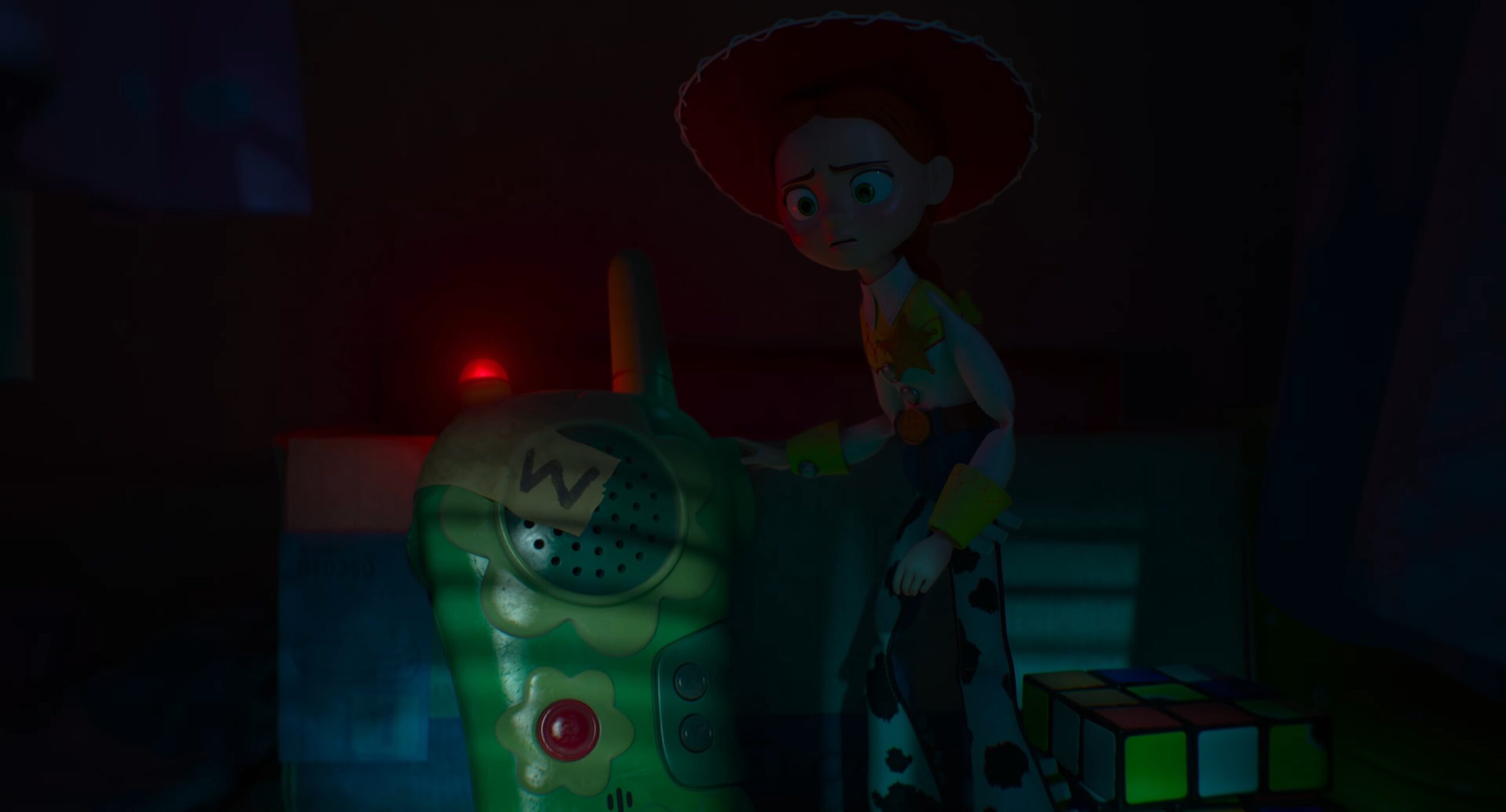 Jessie looking concerned next to a walkie-talkie in Toy Story 5.