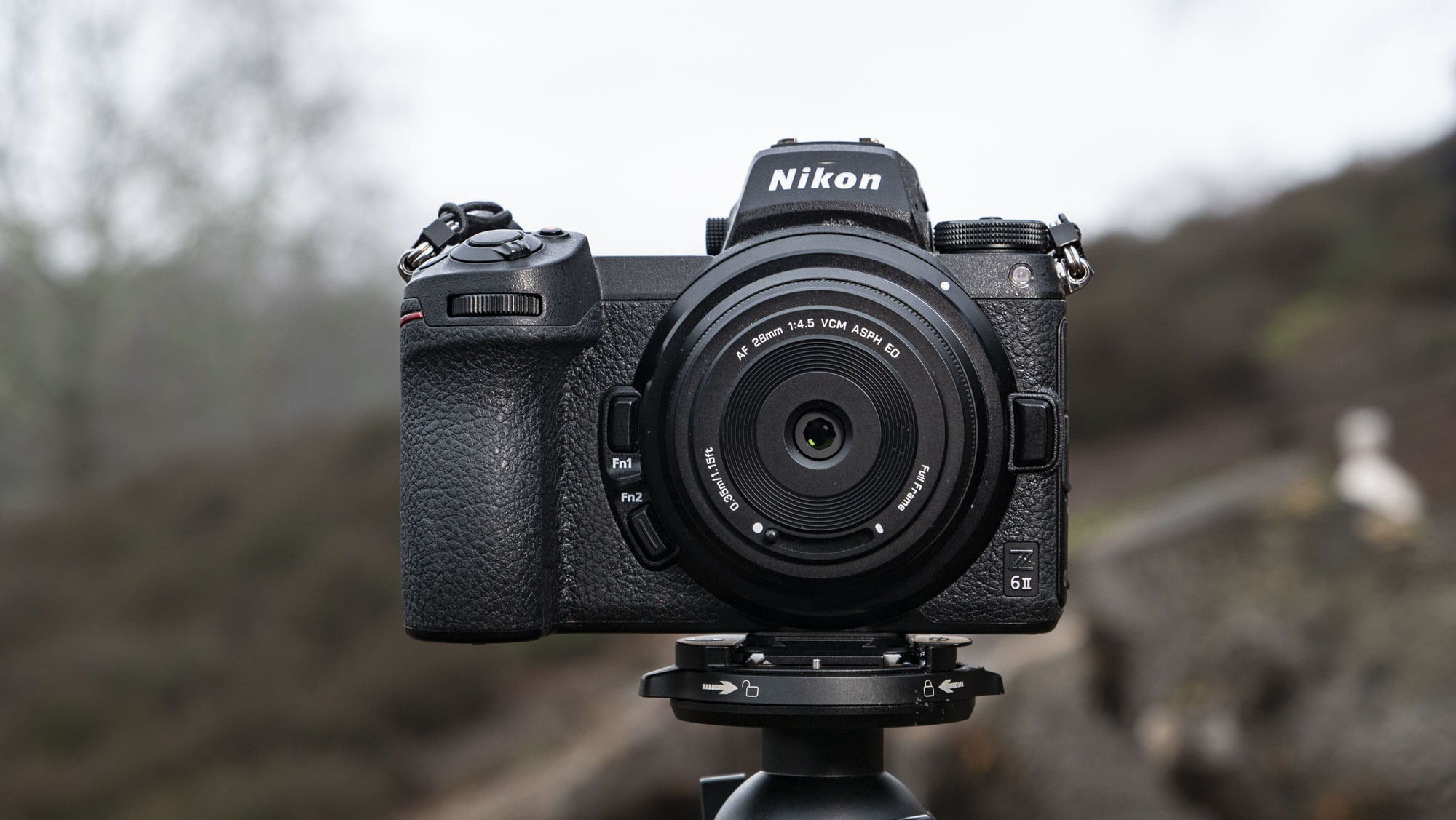 Viltrox AF 28mm f/4.5 body cap lens mounted to a Nikon mirrorless camera, outdoors in open nature