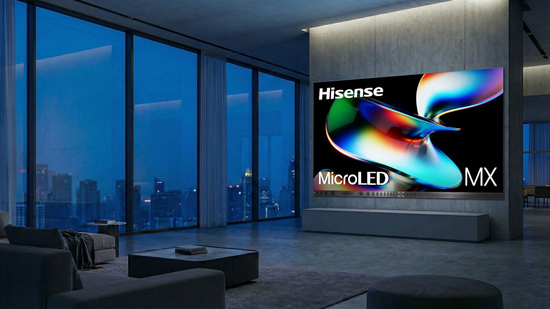The Hisense 163-inch microLED in a room during the evening with large windows.