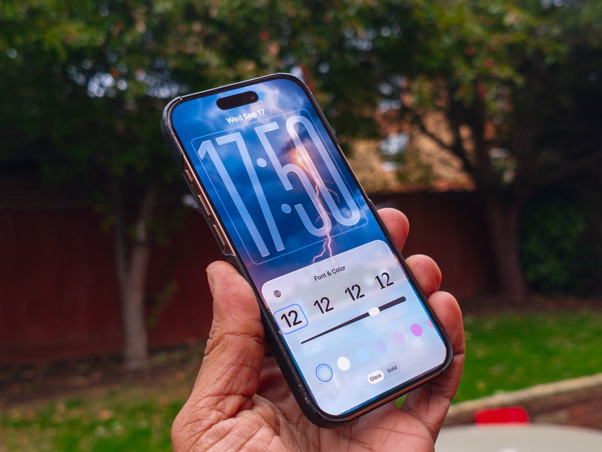Clock font options on the iOS 26 lock screen running on an iPhone 16 Pro