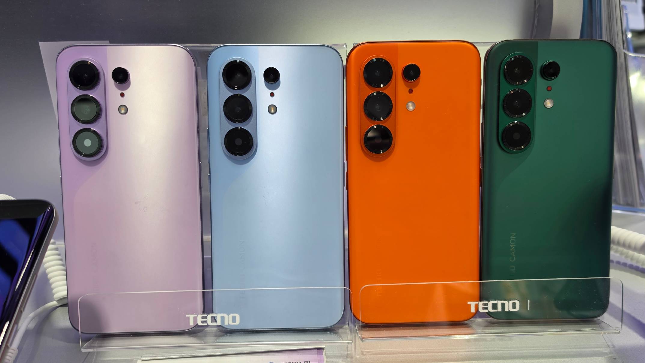 Four Tecno Camon 50 Pro models of different colors in row.