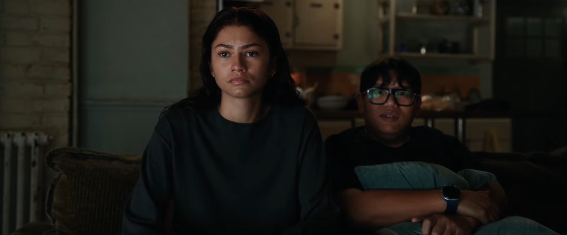 MJ Watson (Zendaya) and Ned Leeds (Jacob Batalon) sitting on a couch in the Marvel film, Spider-Man: Brand New Day.