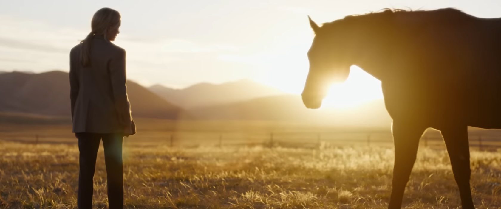 Michelle Pfeiffer standing next to a horse in The Madison.