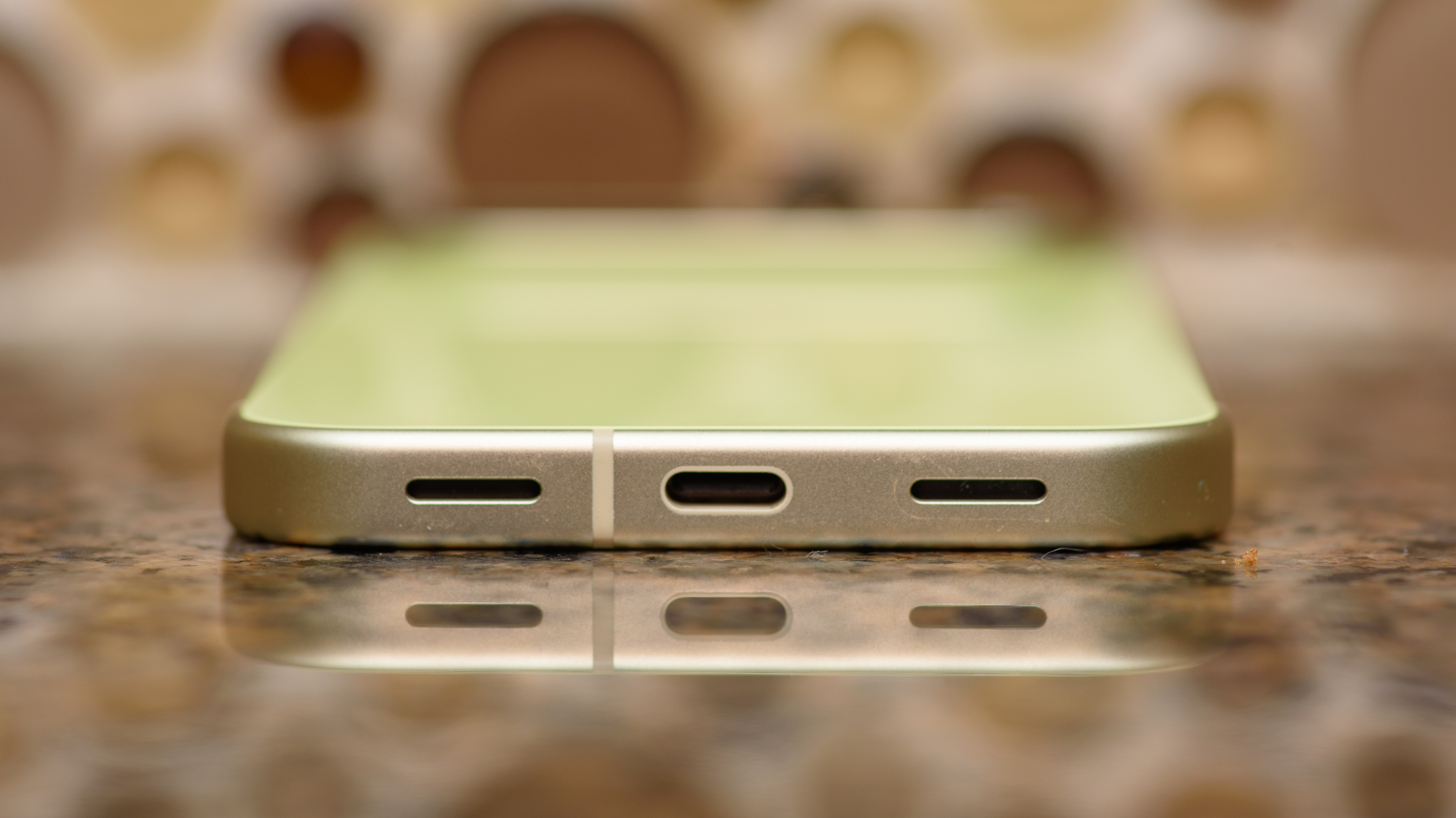 Google Pixel 10 in Lemongrass against a bubbly backsplash