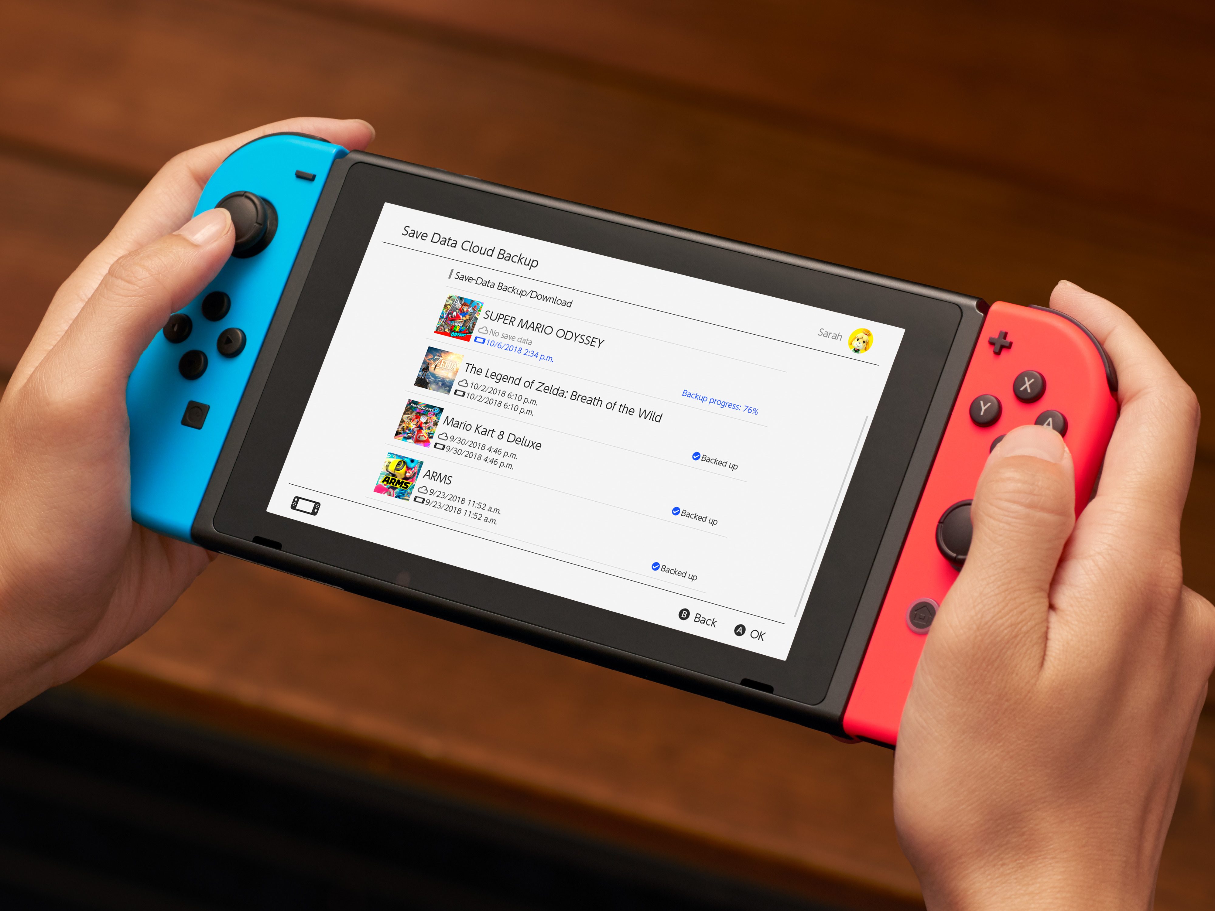A Nintendo Switch with a list of cloud saves on the display.