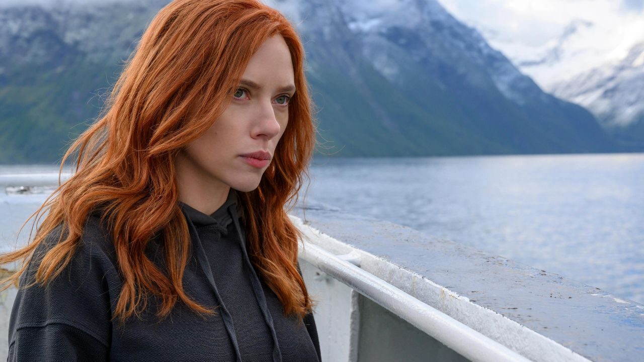 Natasha Romanoff (Scarlett Johansson) looking to the distance with a pensive expression in the Marvel Studios film, Black Widow.