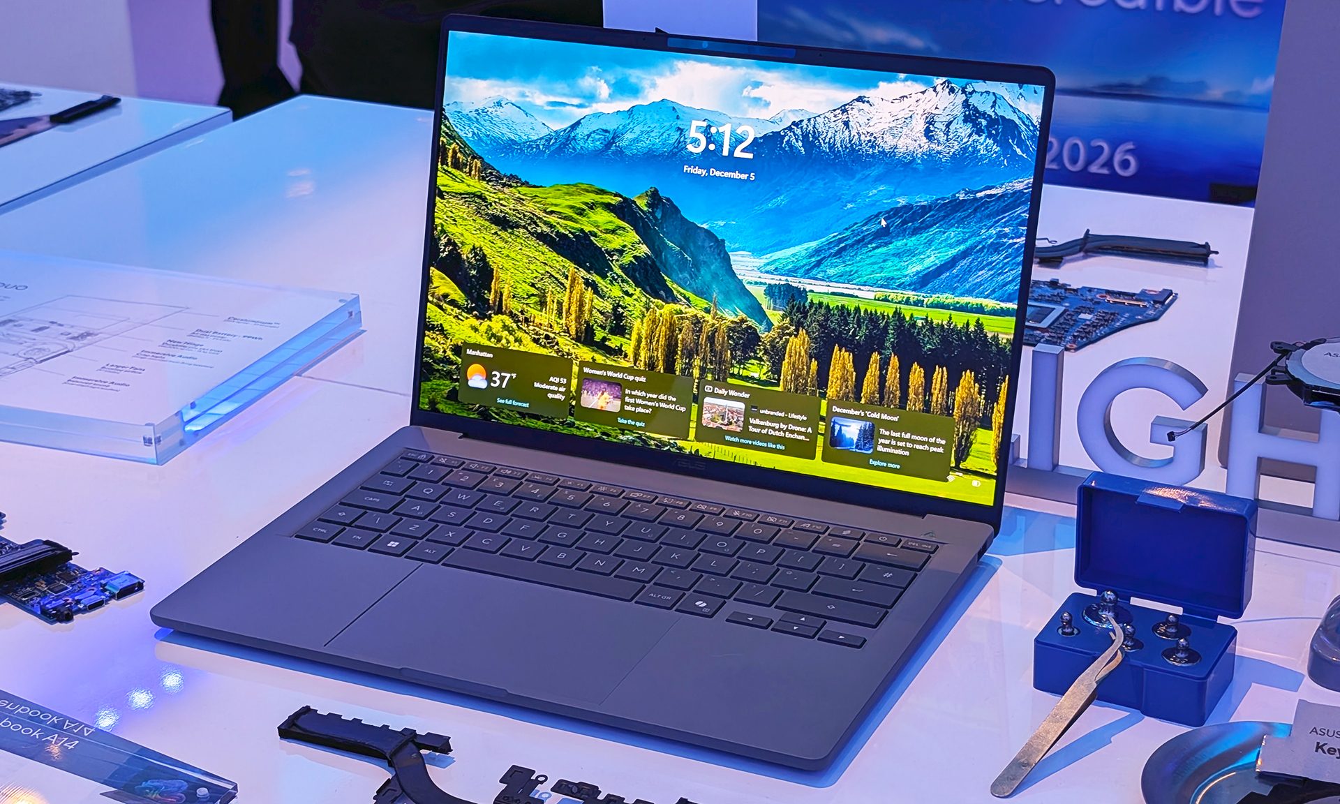 Zenbook A14 sitting open on a white table.