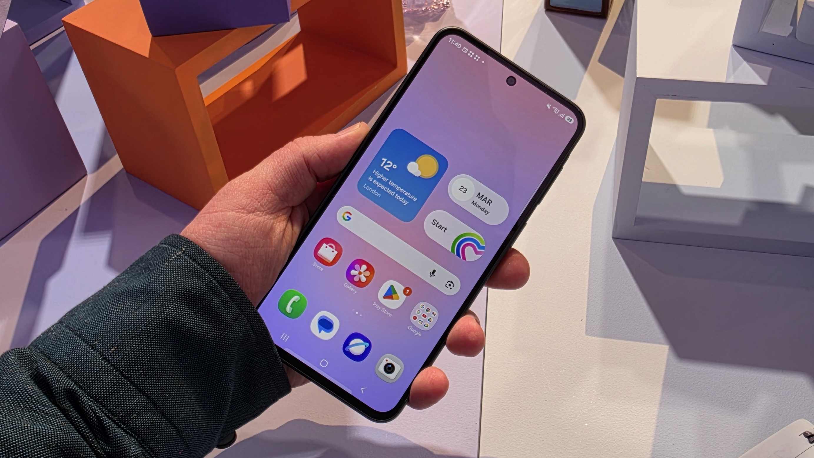 The Samsung Galaxy A37 in a man's hand, showing its main menu.