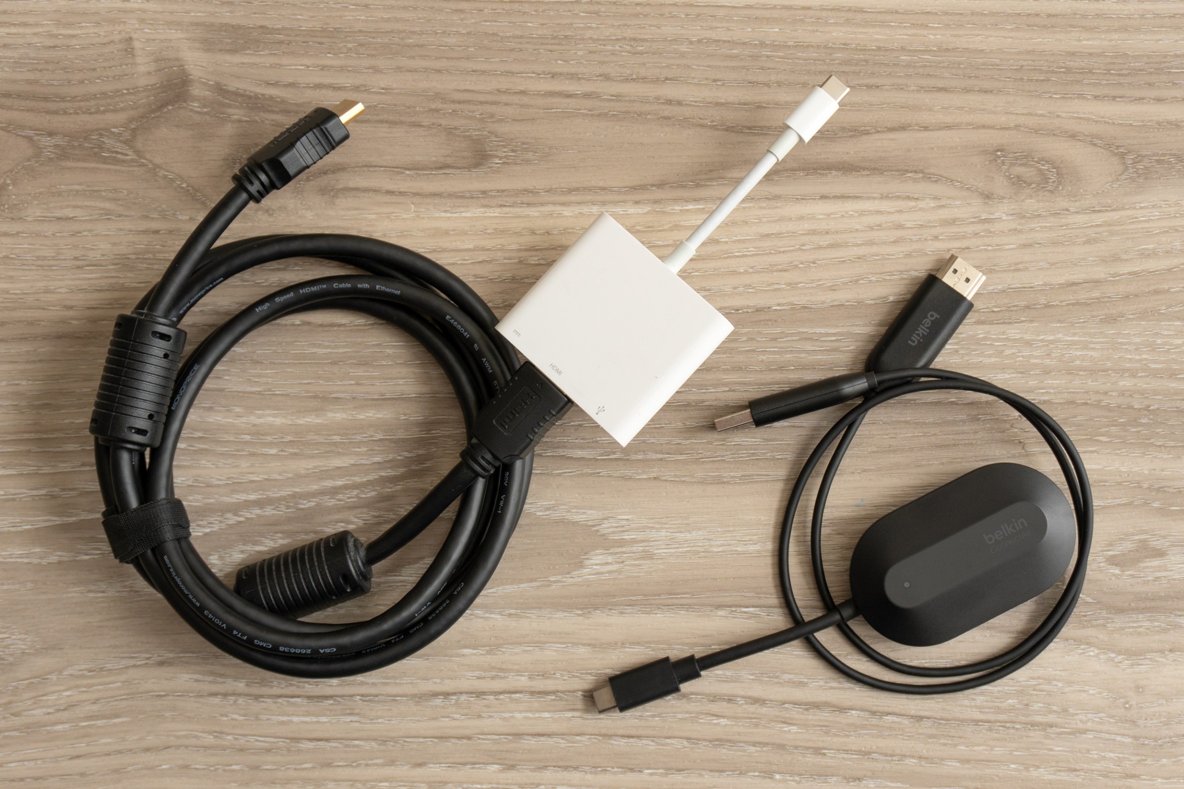 A wound HDMI video cable attached to an adapter next to Belkin’s ConnectAir transmitter and receiver.