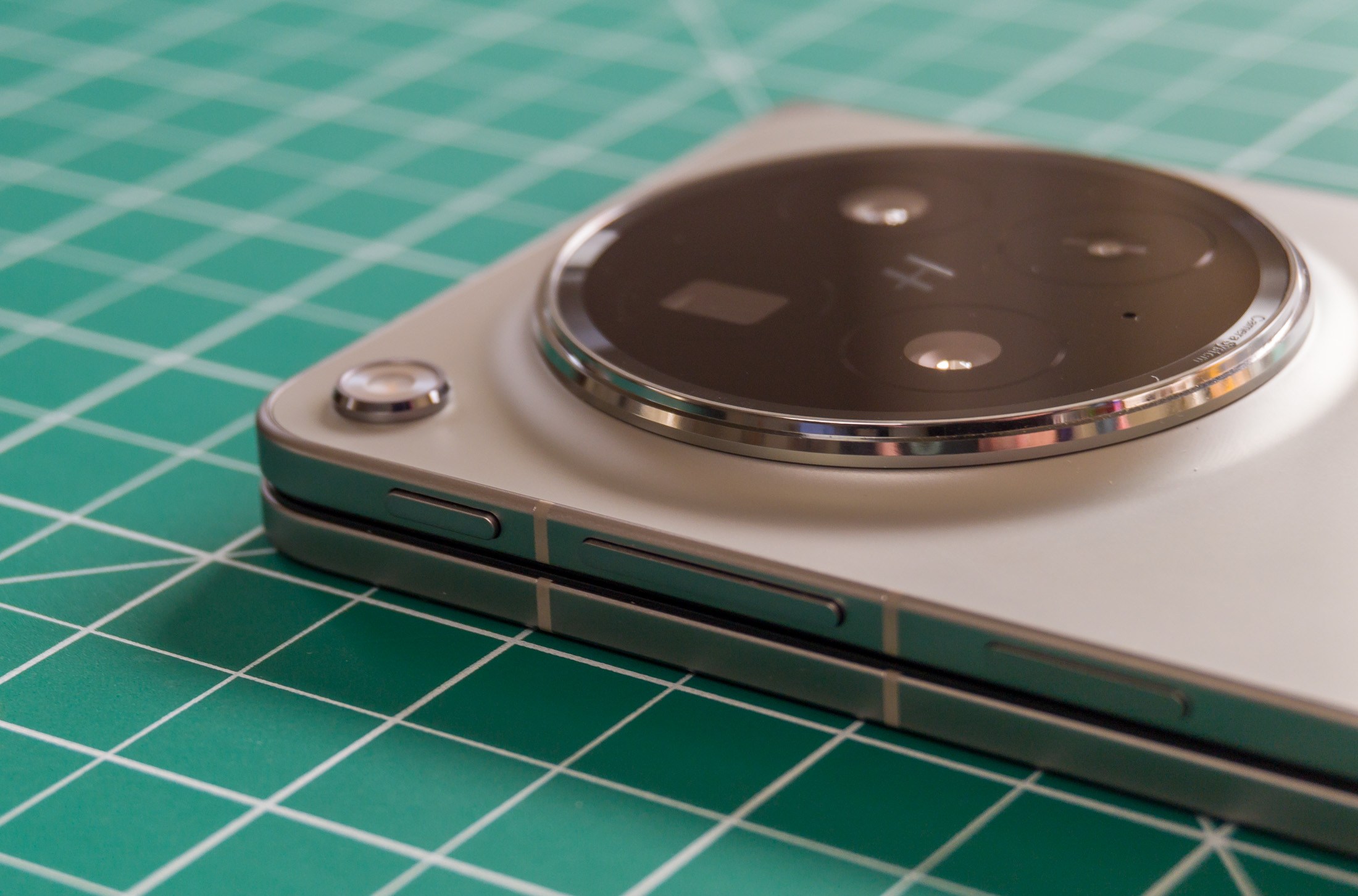 Photo of Oppo Find N6 on a green work mat from above at an angle, centered on the rear camera