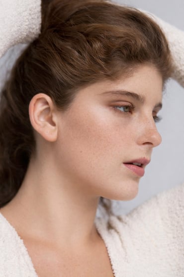 A beautiful woman facing to the side.