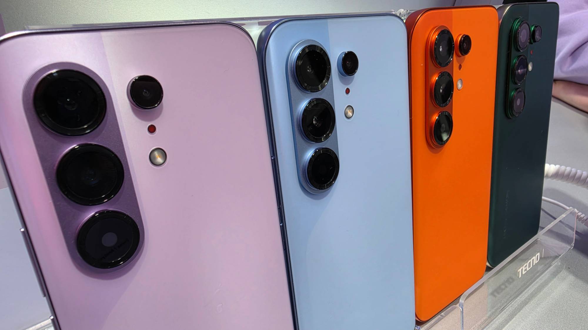 Four Tecno Camon 50 Pro models of different colors in row.