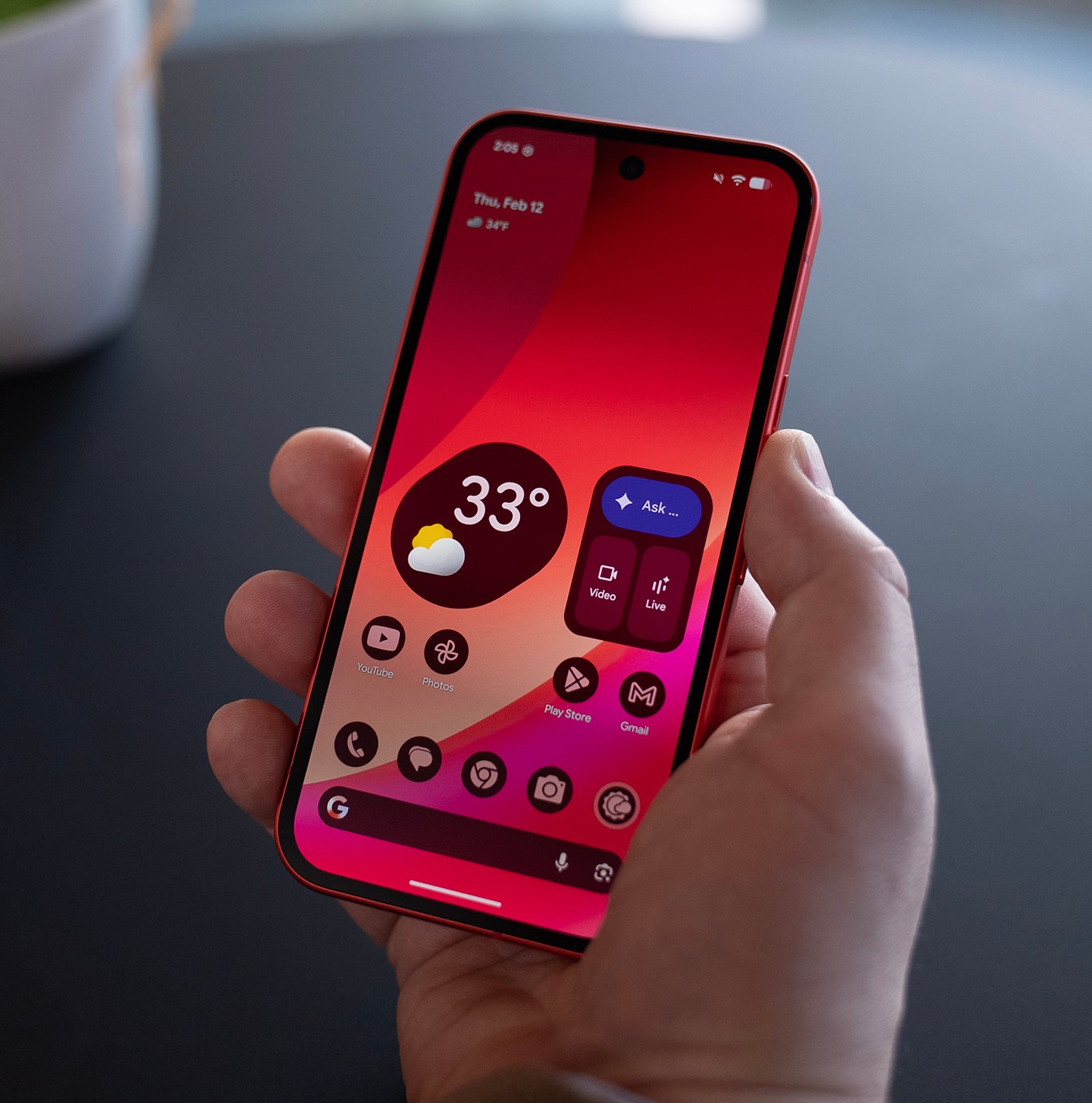 Illuminated screen of a Google Pixel 10A in someone’s hand.