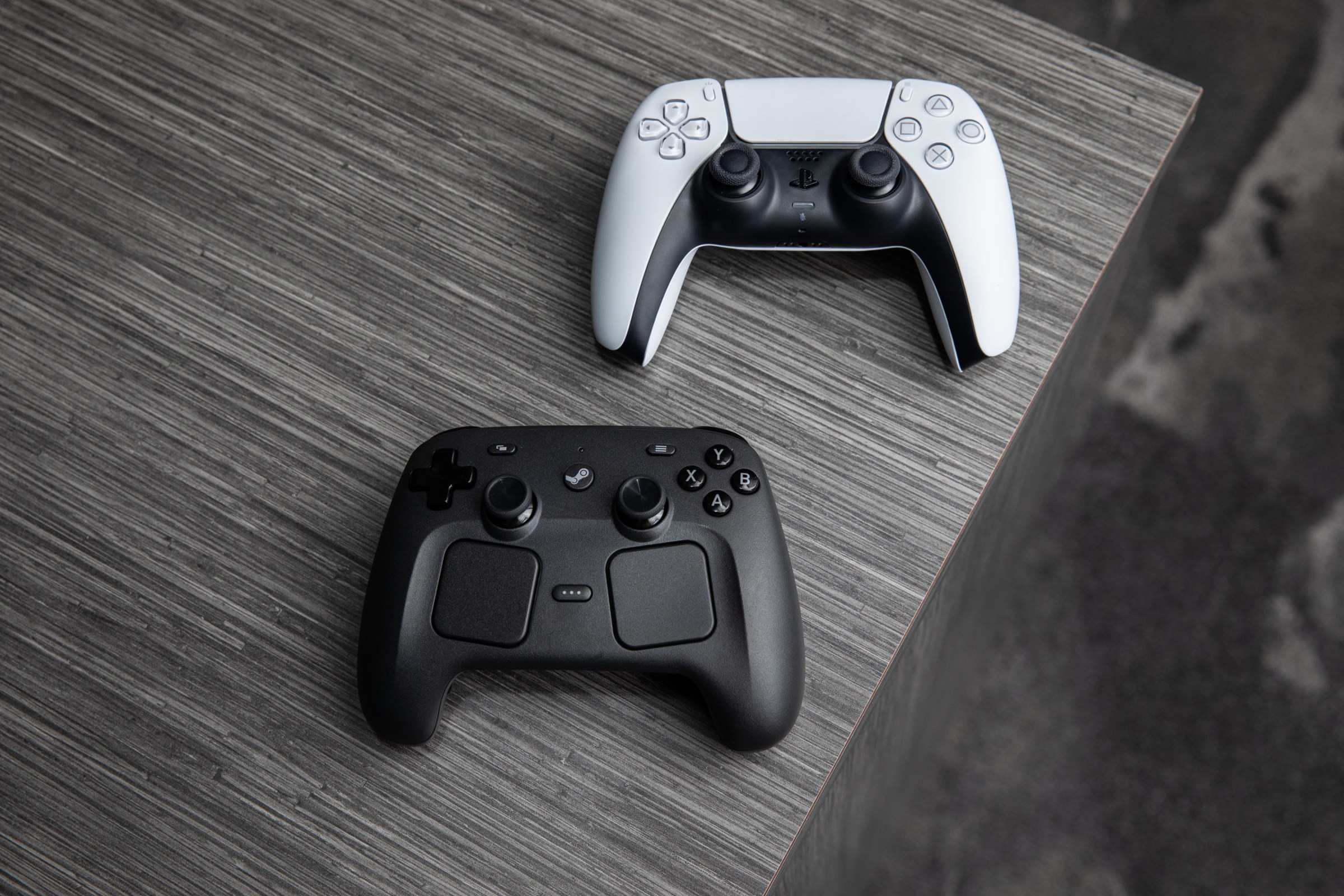 The Steam Controller is similarly sized to its biggest competitor, the DualSense, and has a similar stick layout (but they’re a bit higher up).