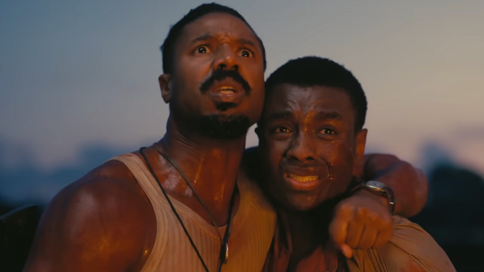 Michael B. Jordan holding Miles Caton in Sinners.