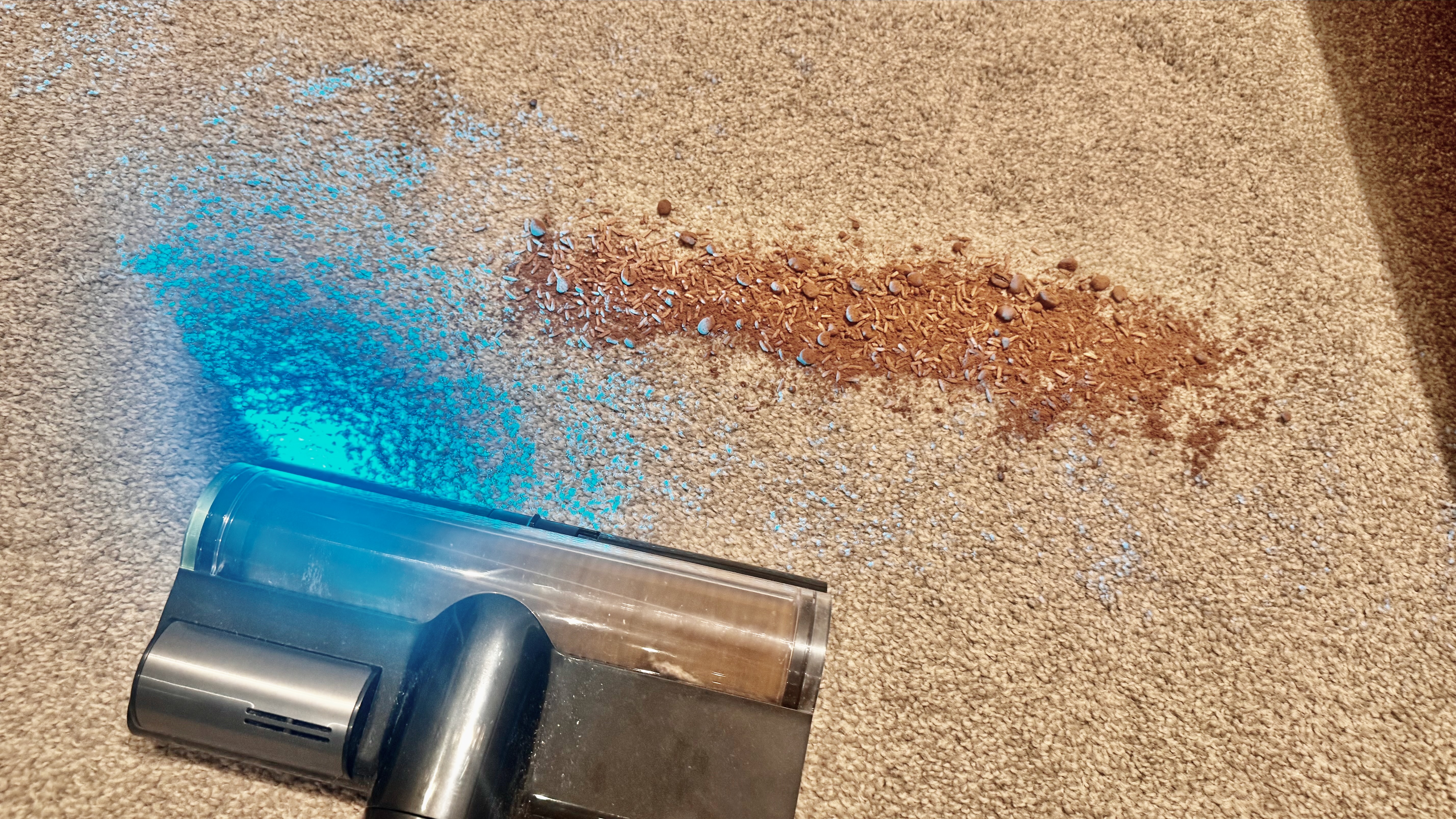 Debris spill being cleaned from a carpet