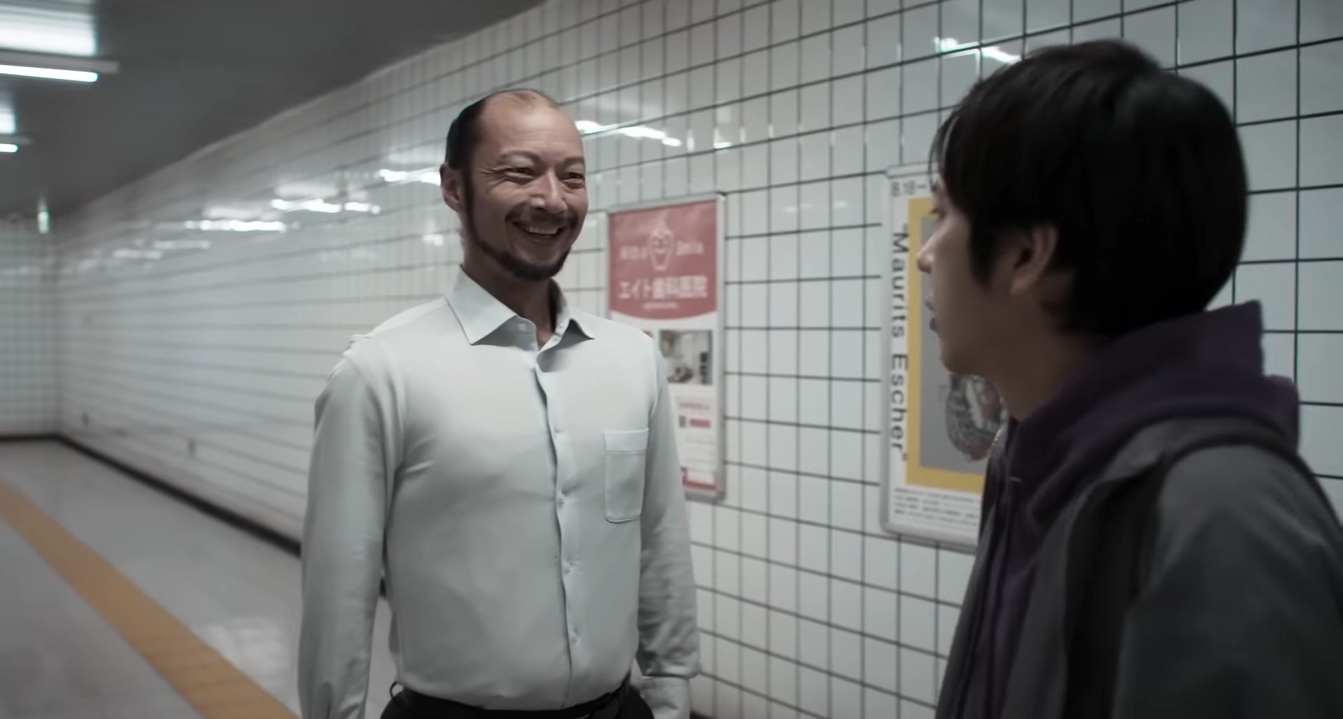 Yamato Kochi smiling at Kazunari Ninomiya in the horror film, Exit 8.