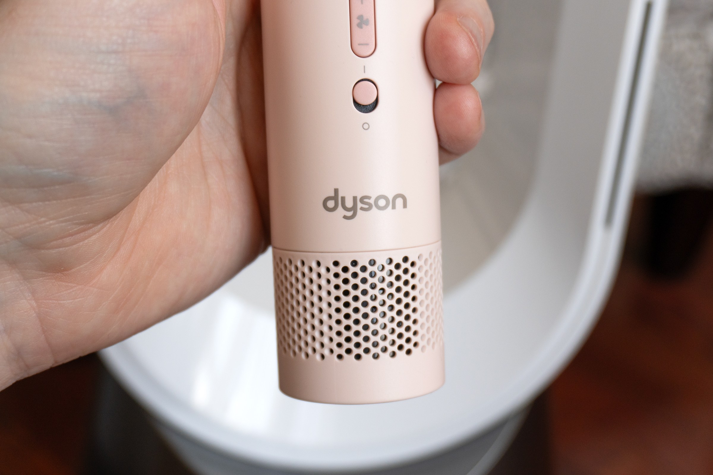 A close-up of the air intake vent on the bottom of the Dyson HushJet Mini Cool fan.