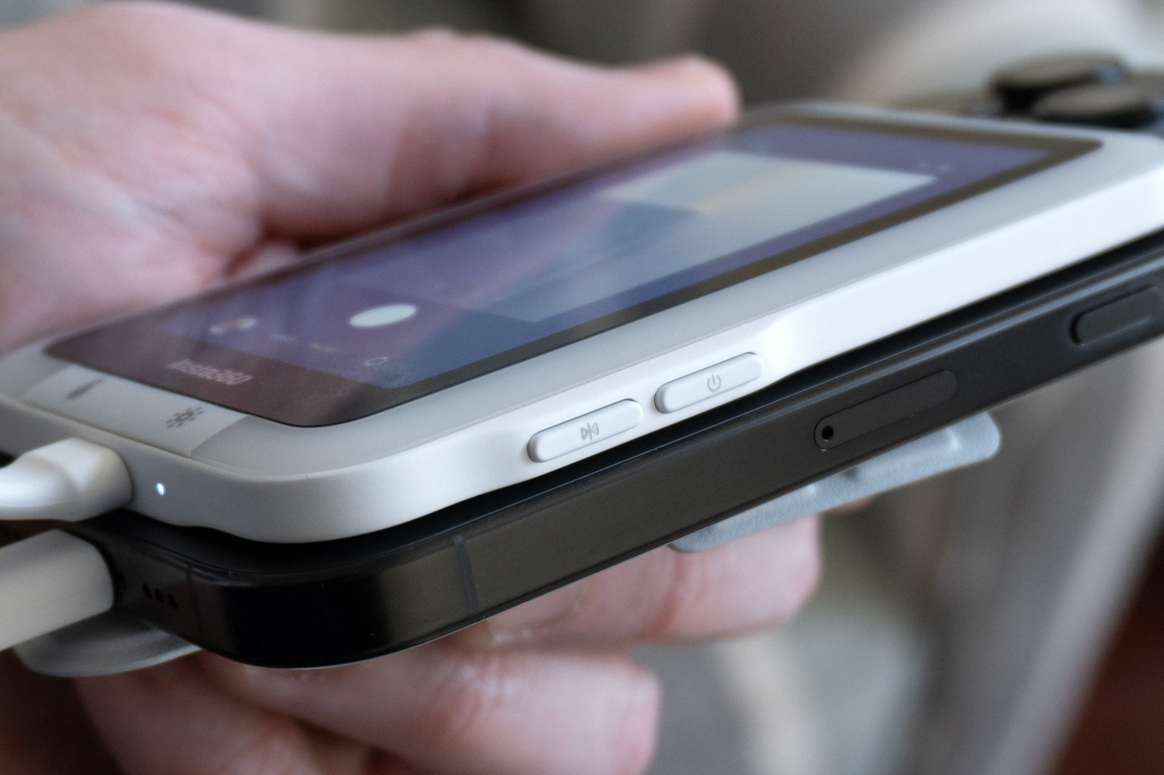 A close-up of two buttons on the side of the Insta360 Snap screen.