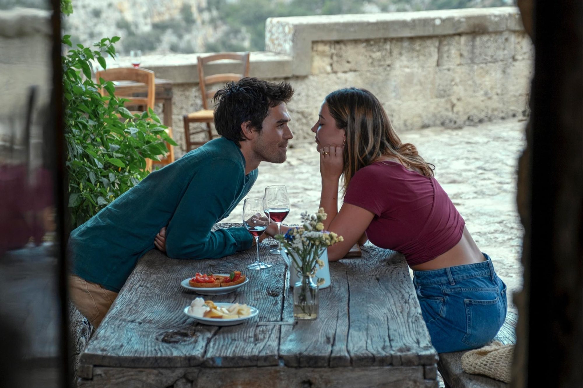 A man and woman sit at a table and stare.