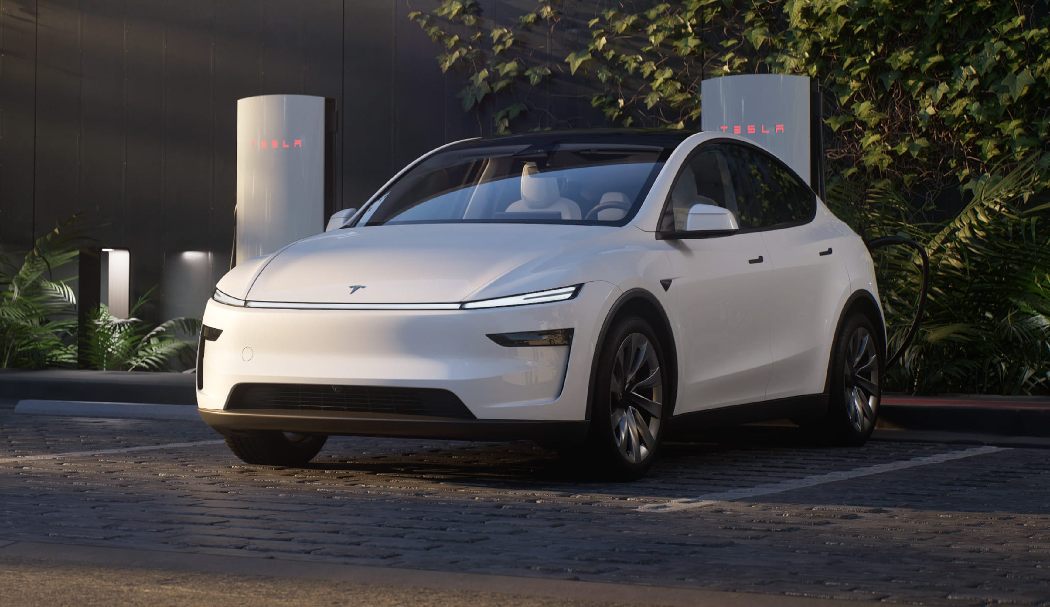 White Tesla Model Y Juniper at a Supercharger