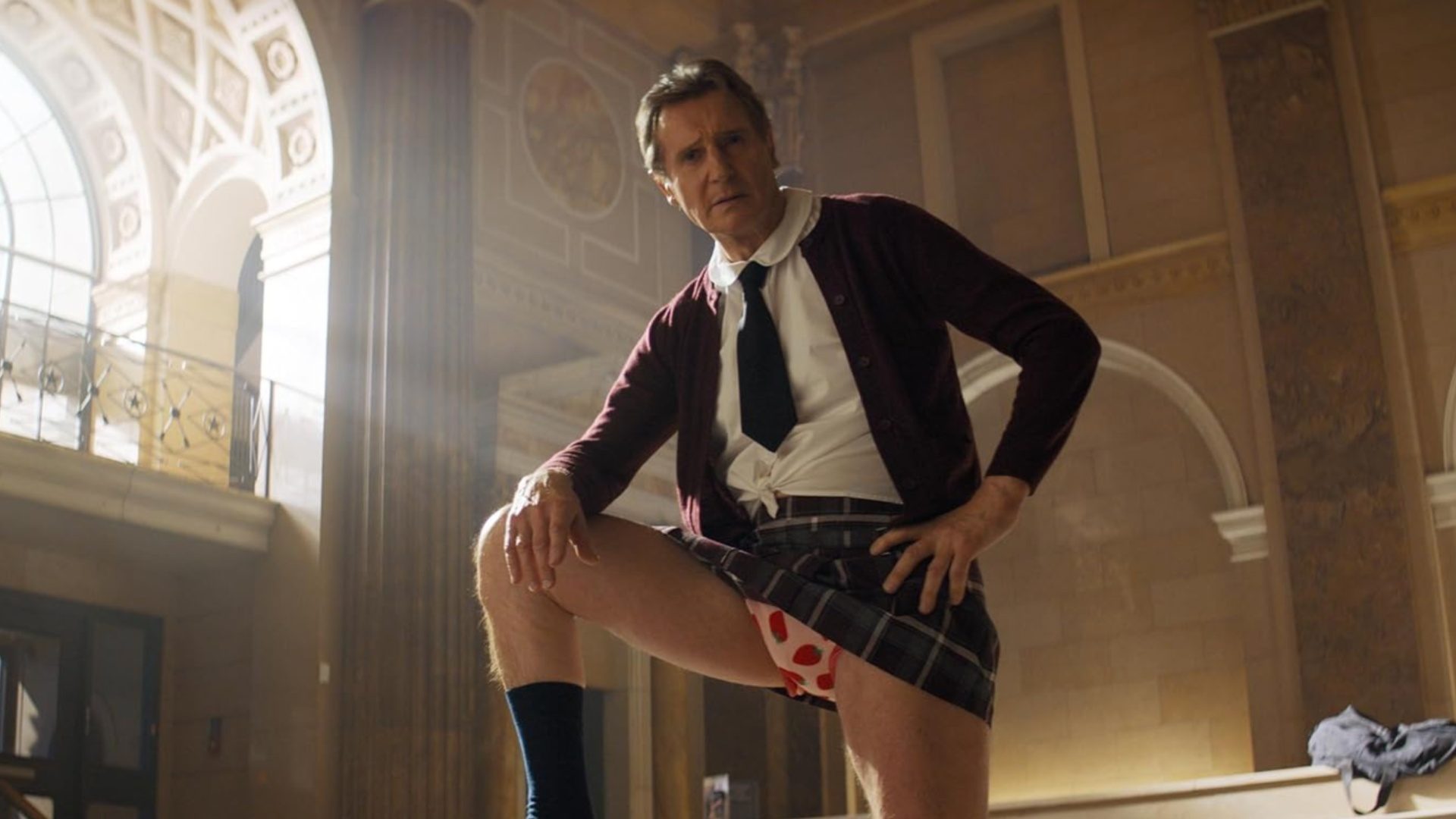 Liam Neeson stands with his underwear showing in The Naked Gun.