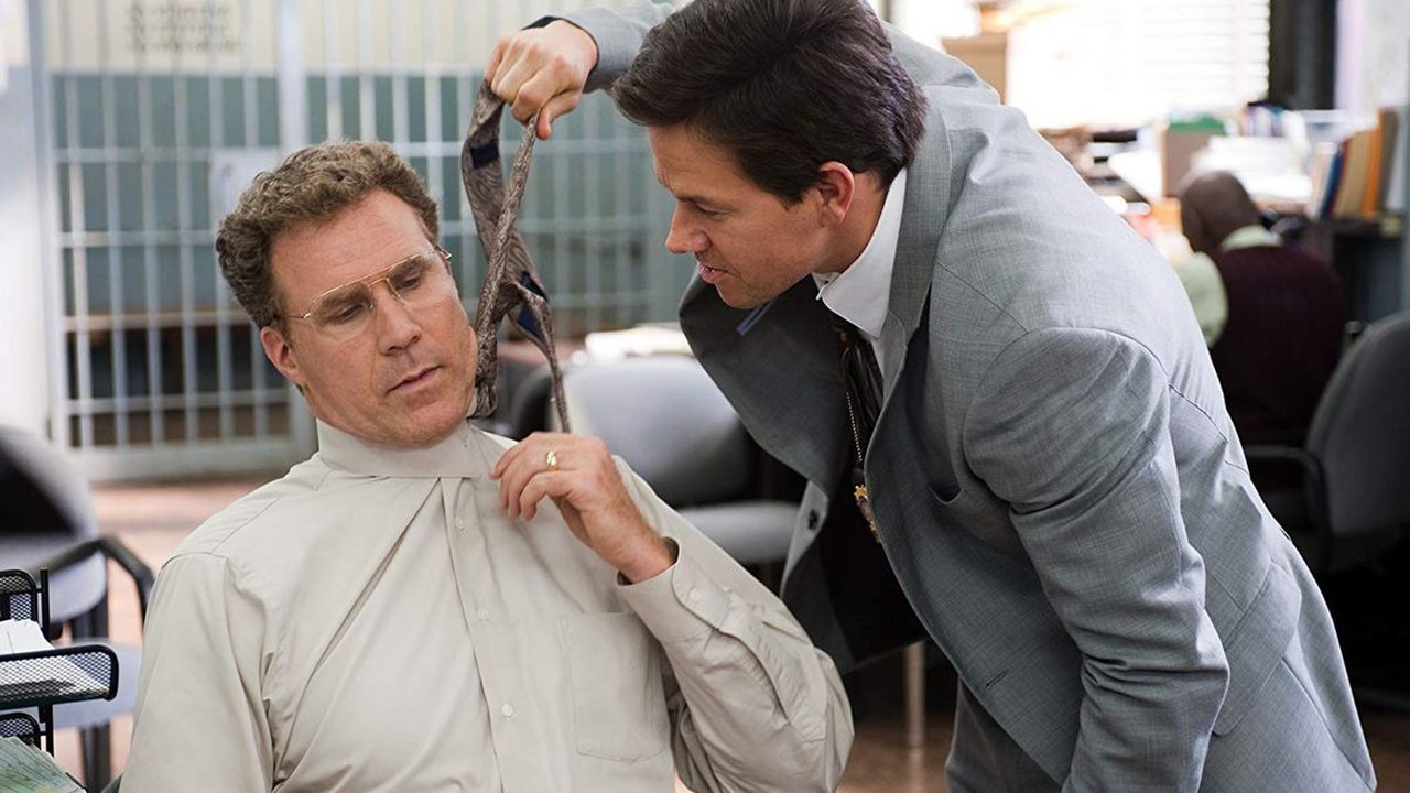 Mark Wahlberg pulling Will Ferrell's tie in a scene from The Other Guys.