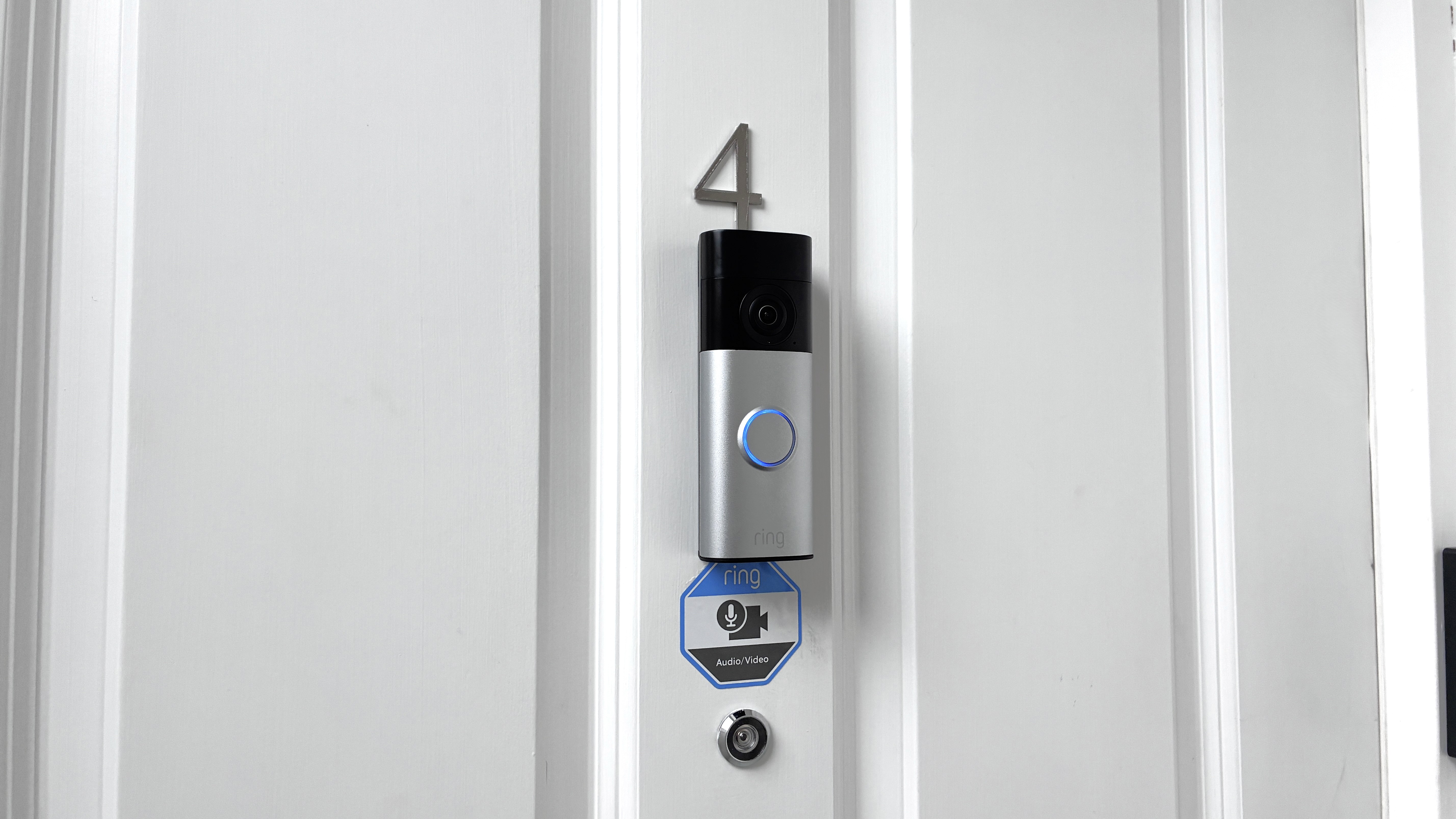 Ring Battery Video Doorbell Plus (2nd Gen) mounted on front door above peephole