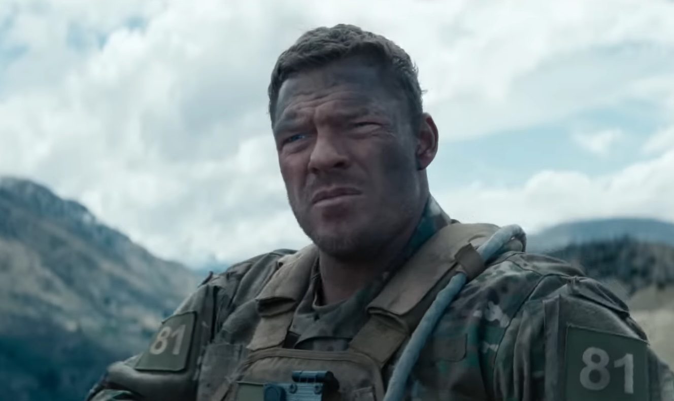 Alan Ritchson as Staff Sergeant 81 looking serious in the 2026 film, War Machine.