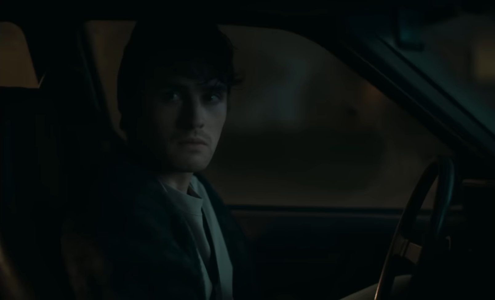 Bear (Michael Johnston) sitting in a car in the horror film, Obsession.