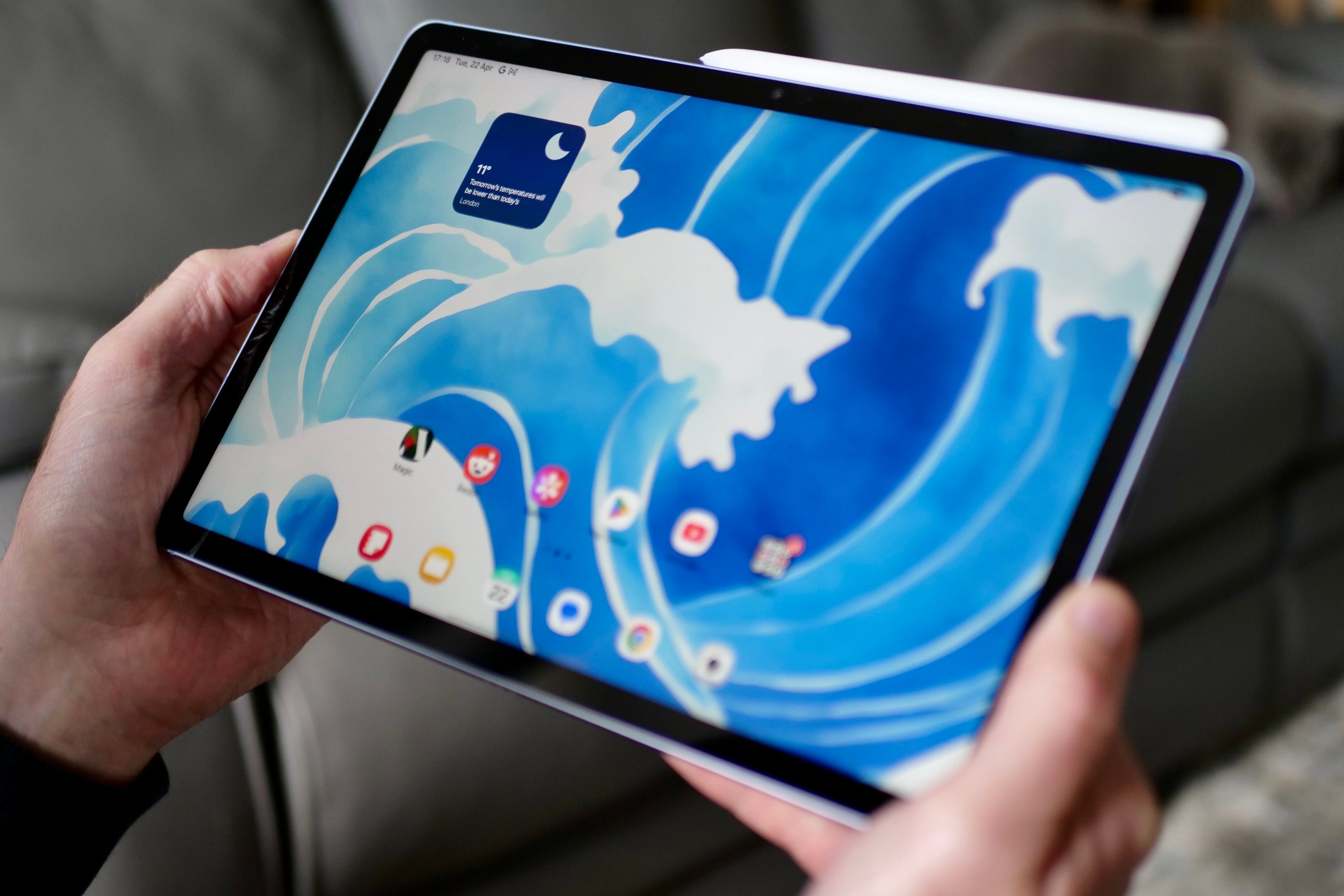 A person holding the Samsung Galaxy Tab S10 FE.