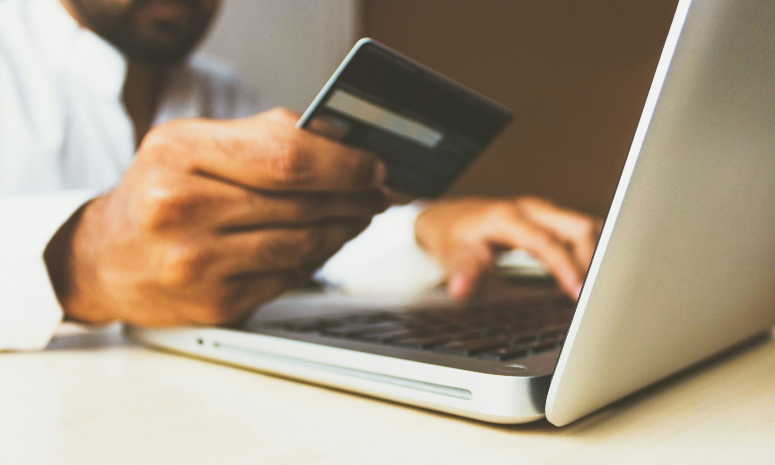 Man with credit card using laptop
