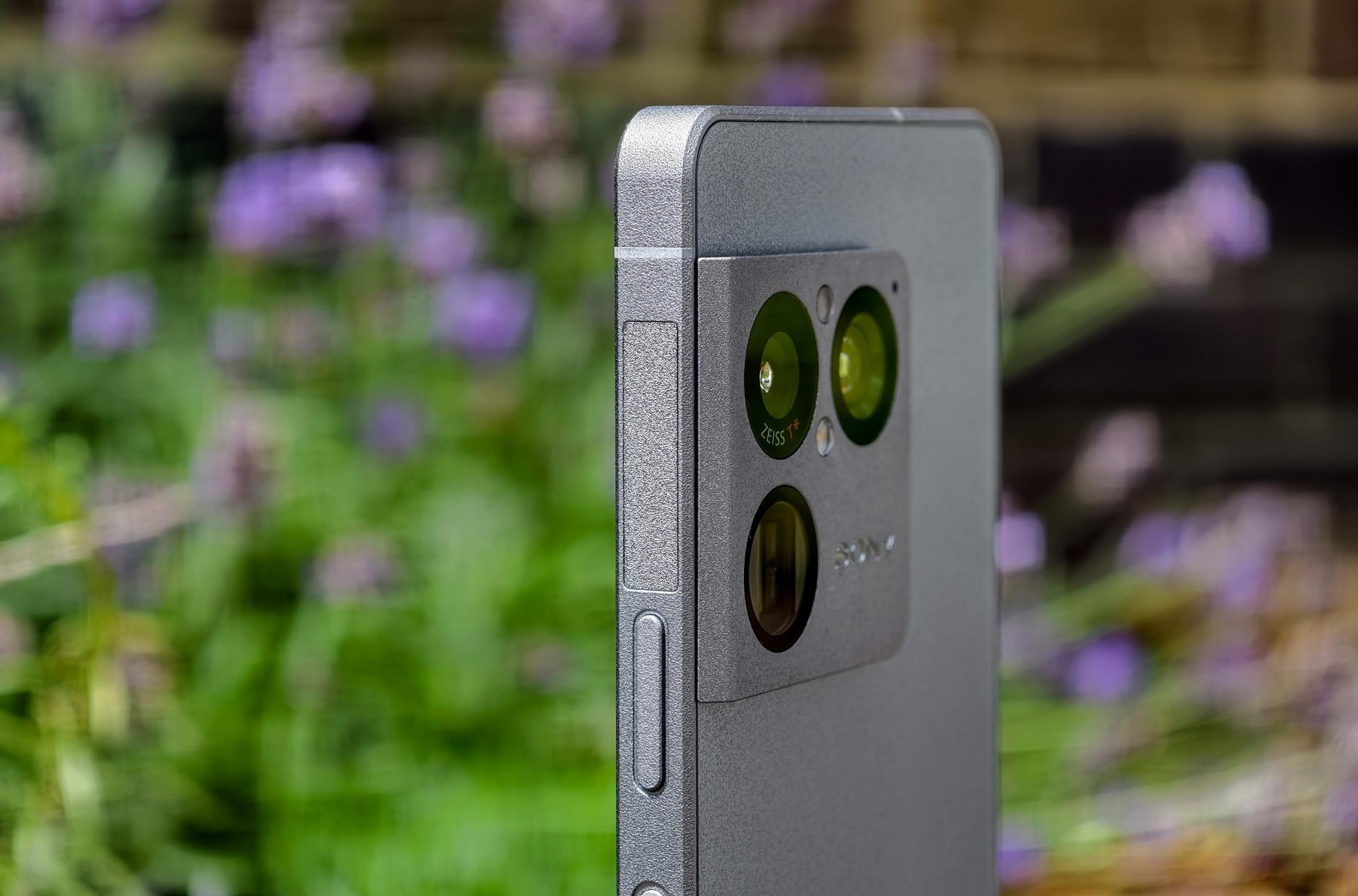 Photo of the Sony Xperia 1 VIII in front of flowers, showing the textured frame and buttons