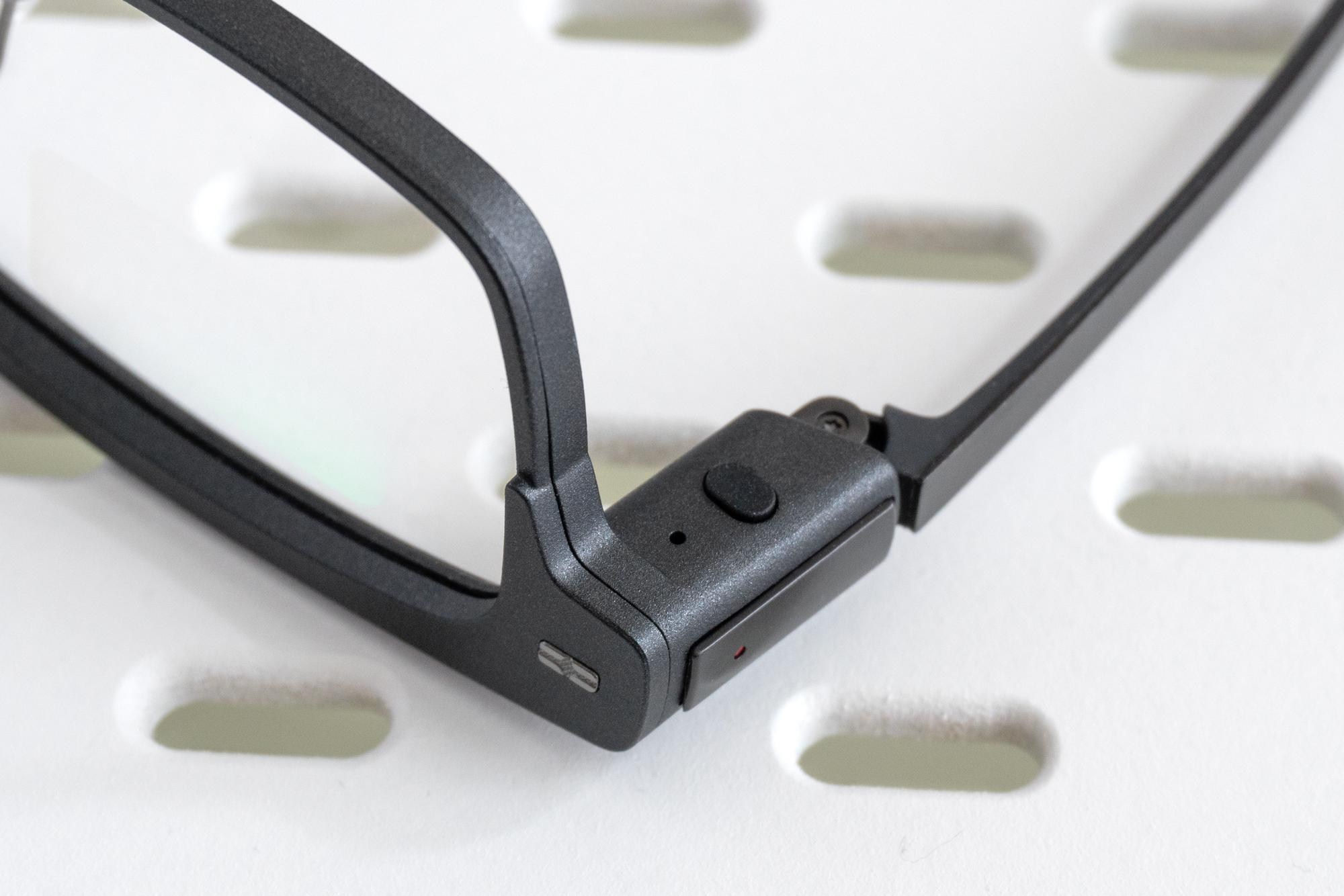 A close-up of the single button on the right side of the Xgimi MemoMind One smart glasses.
