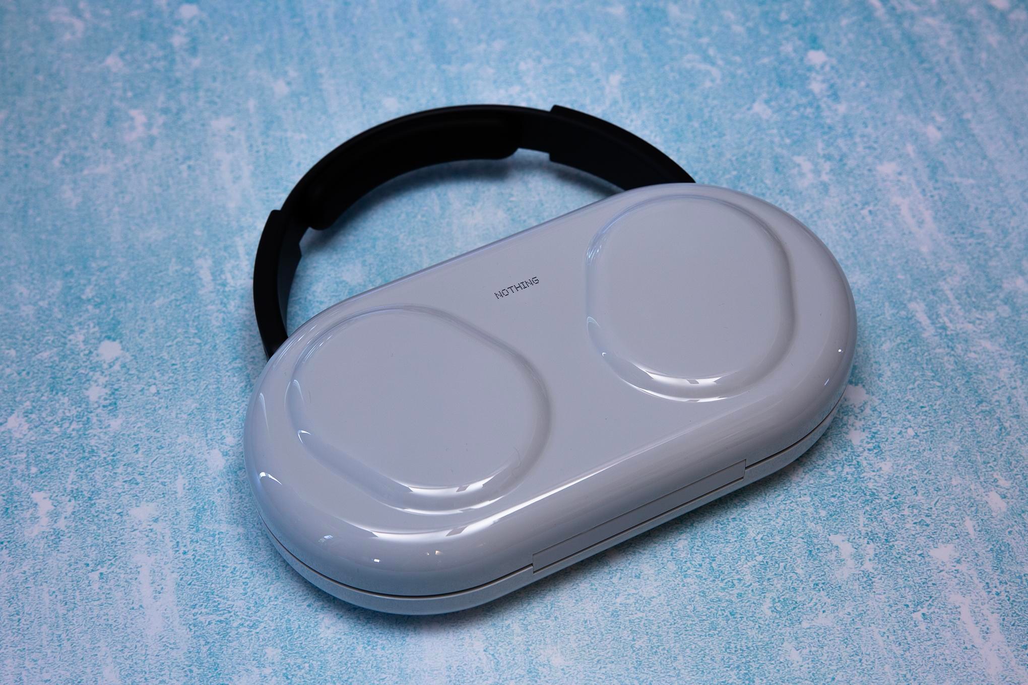 Nothing Pro 1 headphones case on a textured blue background.