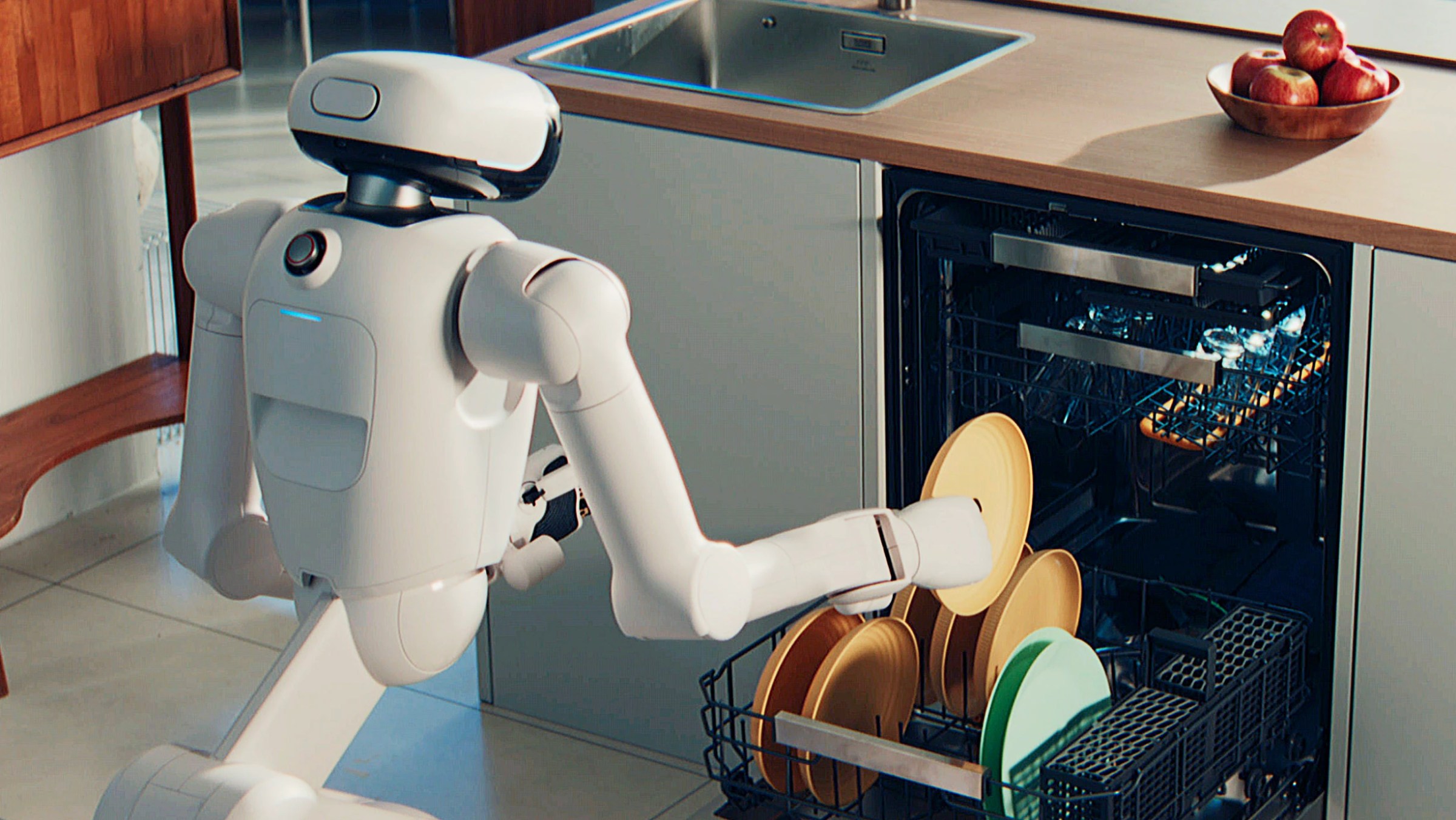 One machine loading dishes into another machine.