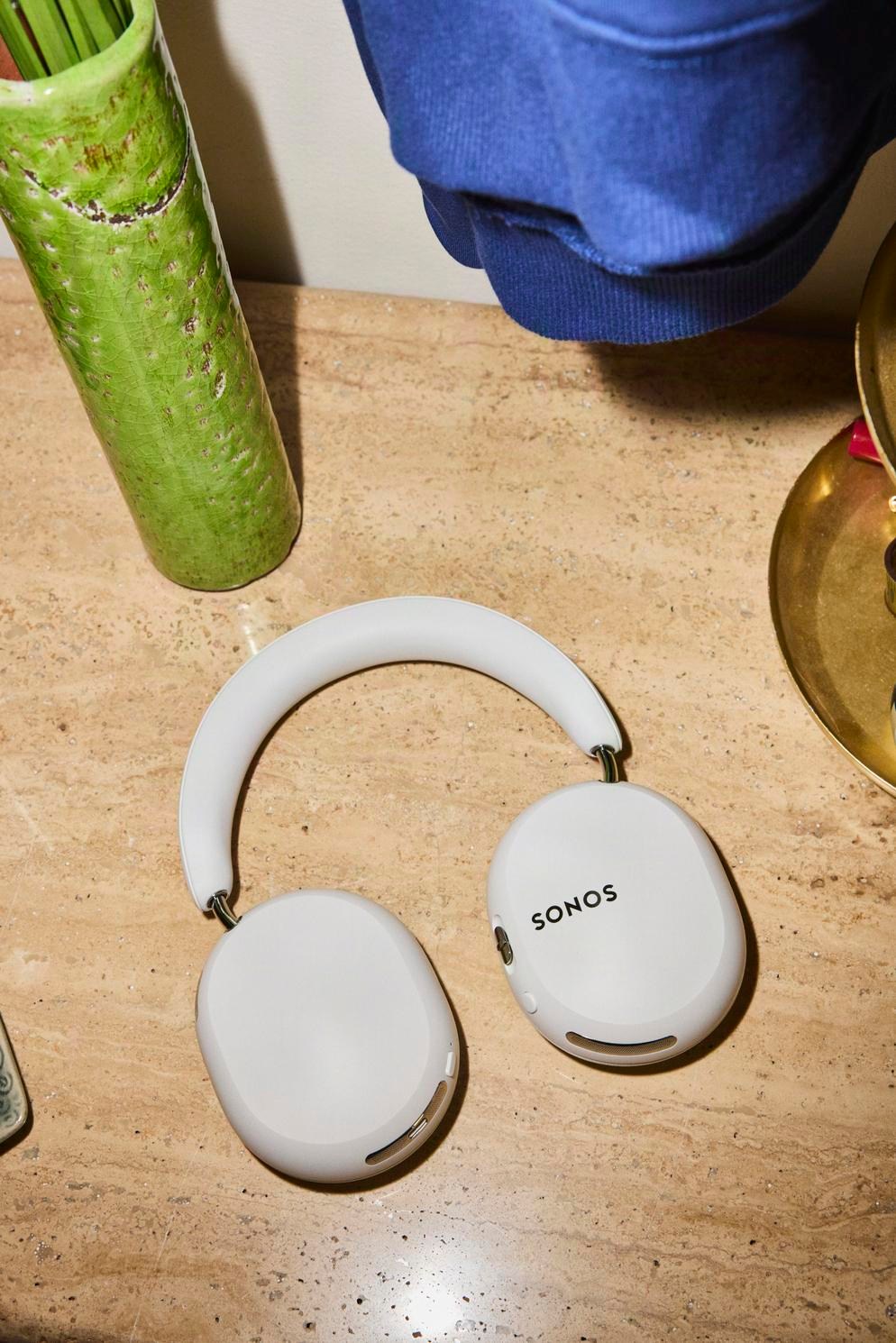 The Sonos Ace Ultra in white on a marble counter.